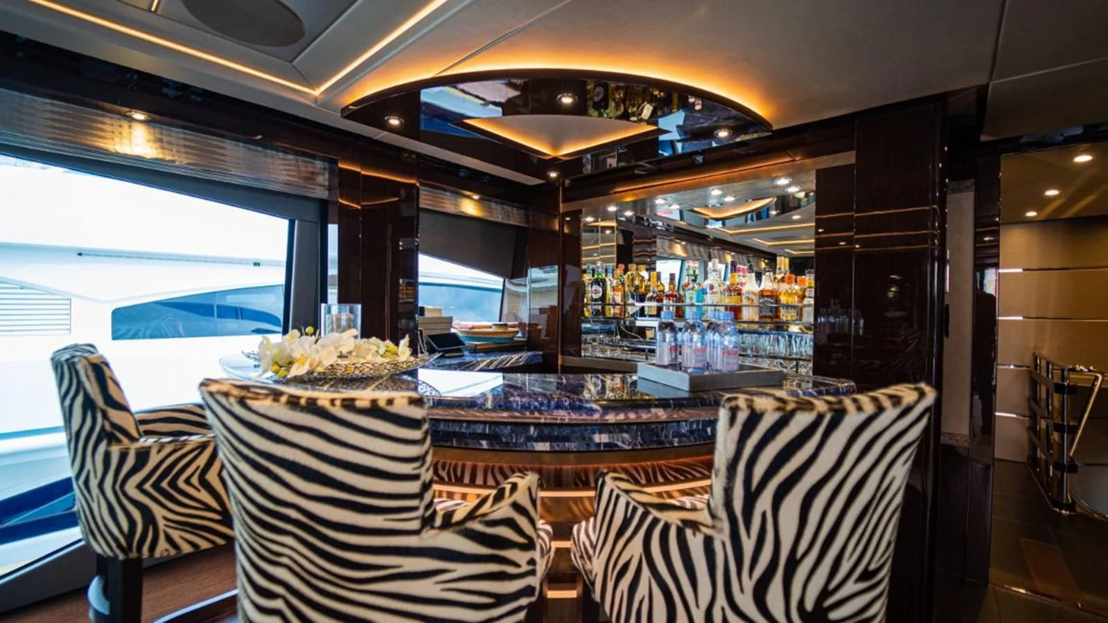 a restaurant with a table and chairs aboard NEXUS Yacht for Charter