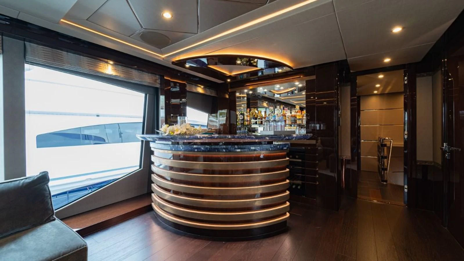 a large glass display case in a room with a wood floor aboard NEXUS Yacht for Charter