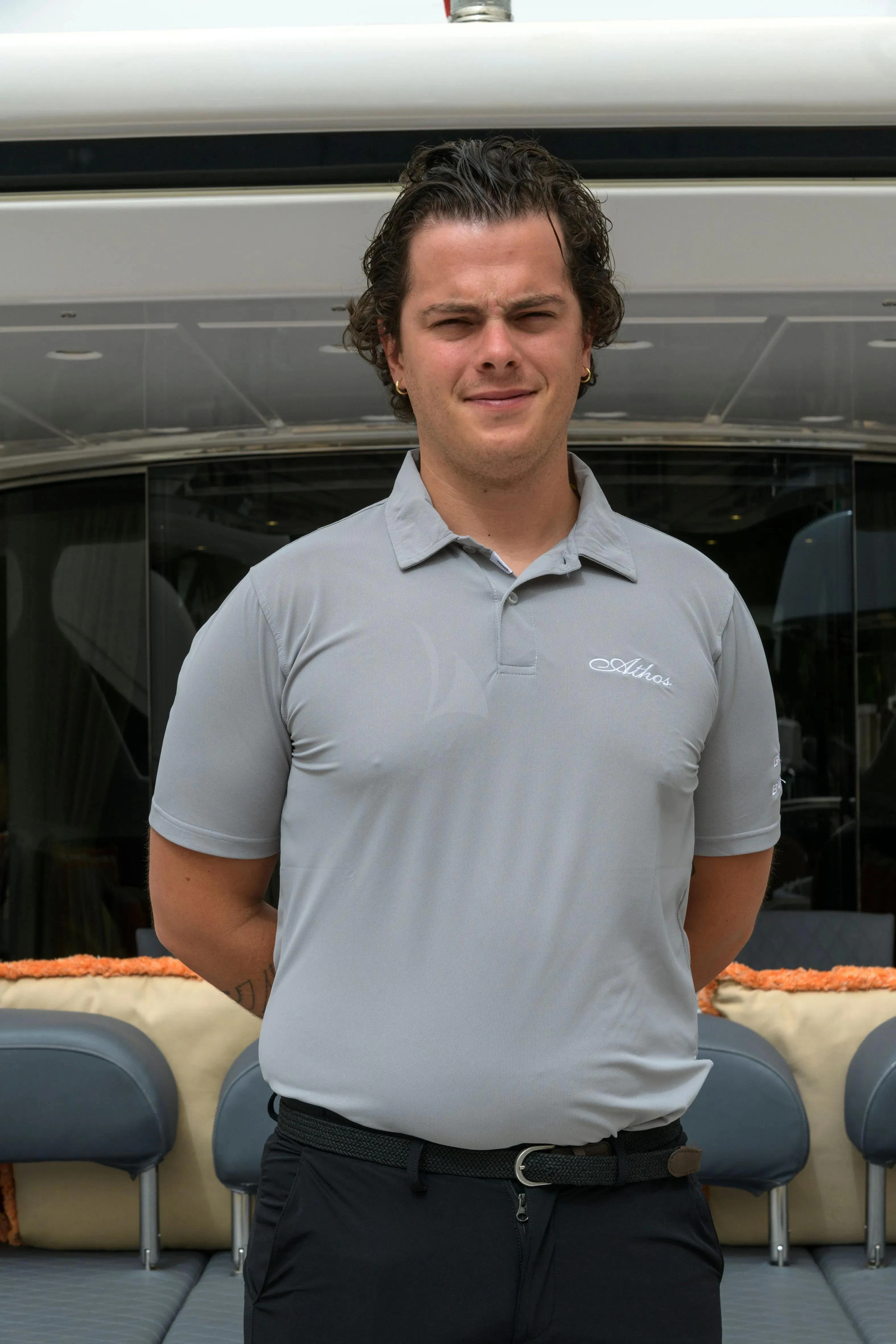 a man standing in front of a bus aboard ATHOS Yacht for Sale