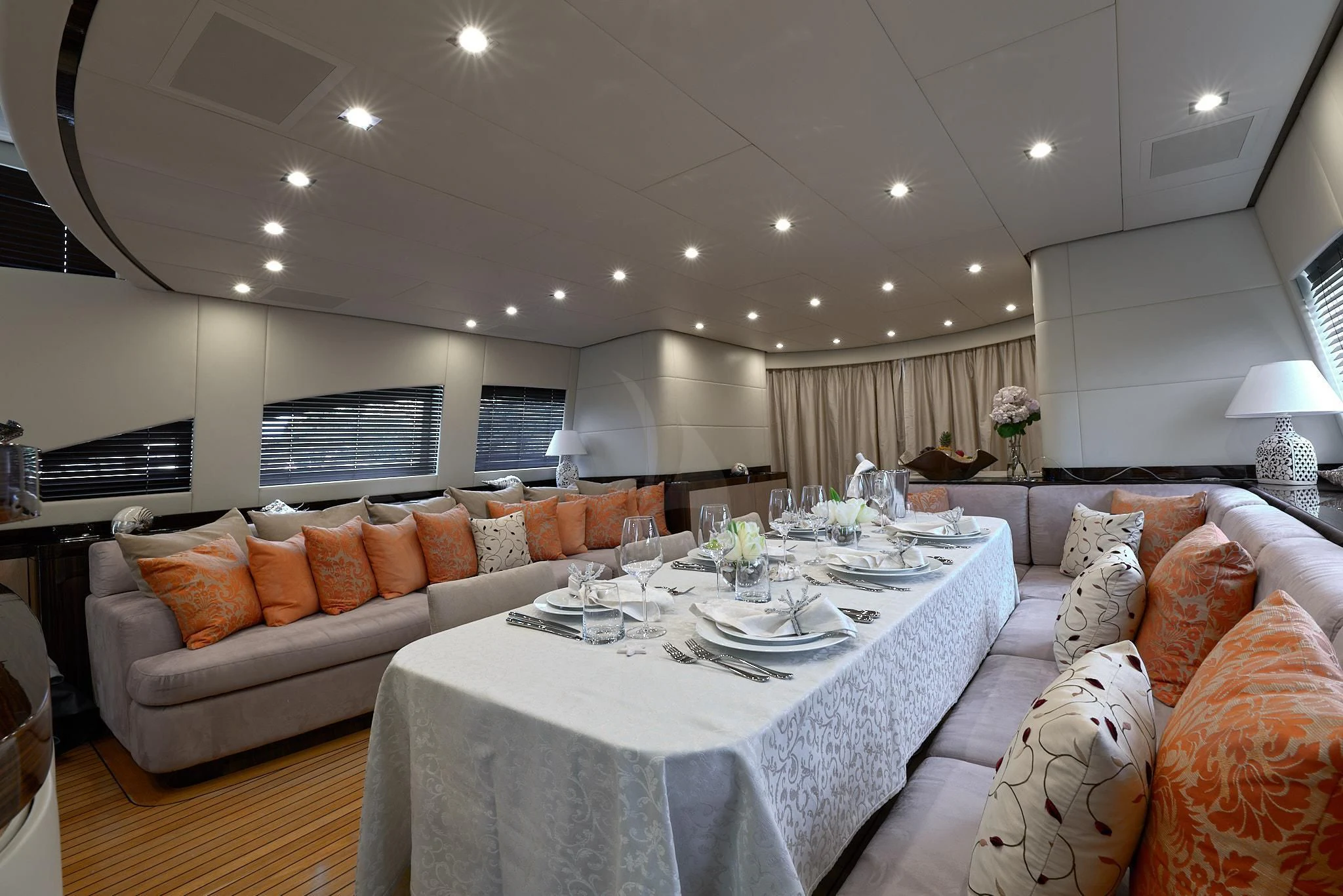 a large white dining table in a living room aboard ATHOS Yacht for Sale
