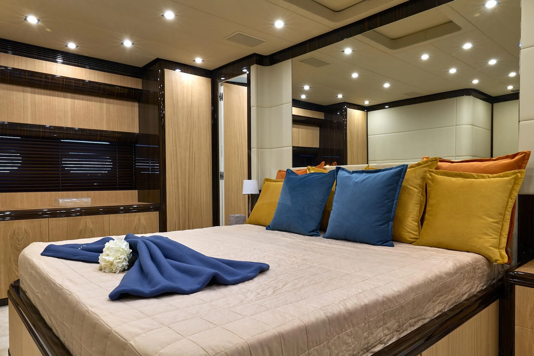 a bed with blue pillows aboard ATHOS Yacht for Sale