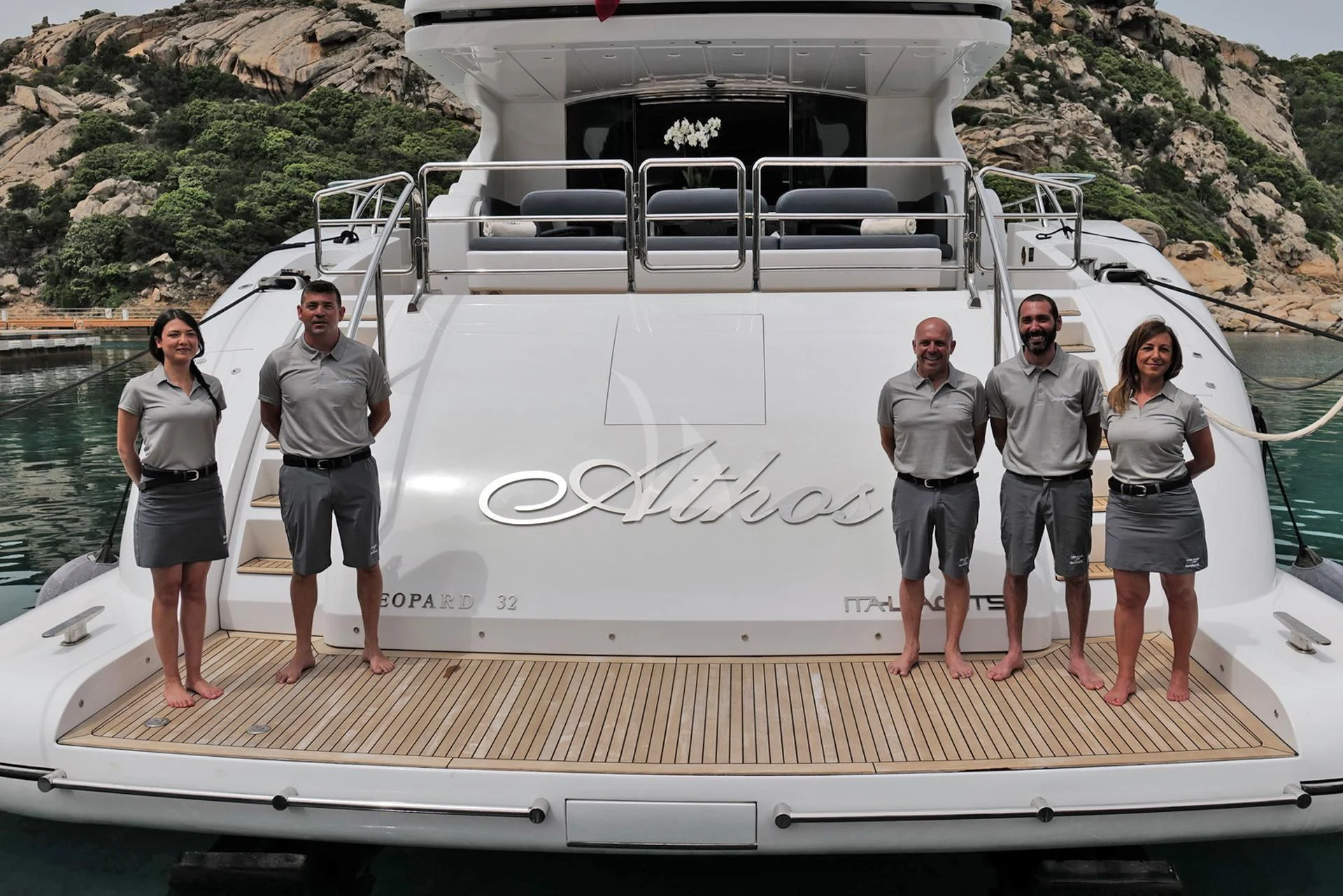 a group of people standing on a boat aboard ATHOS Yacht for Sale
