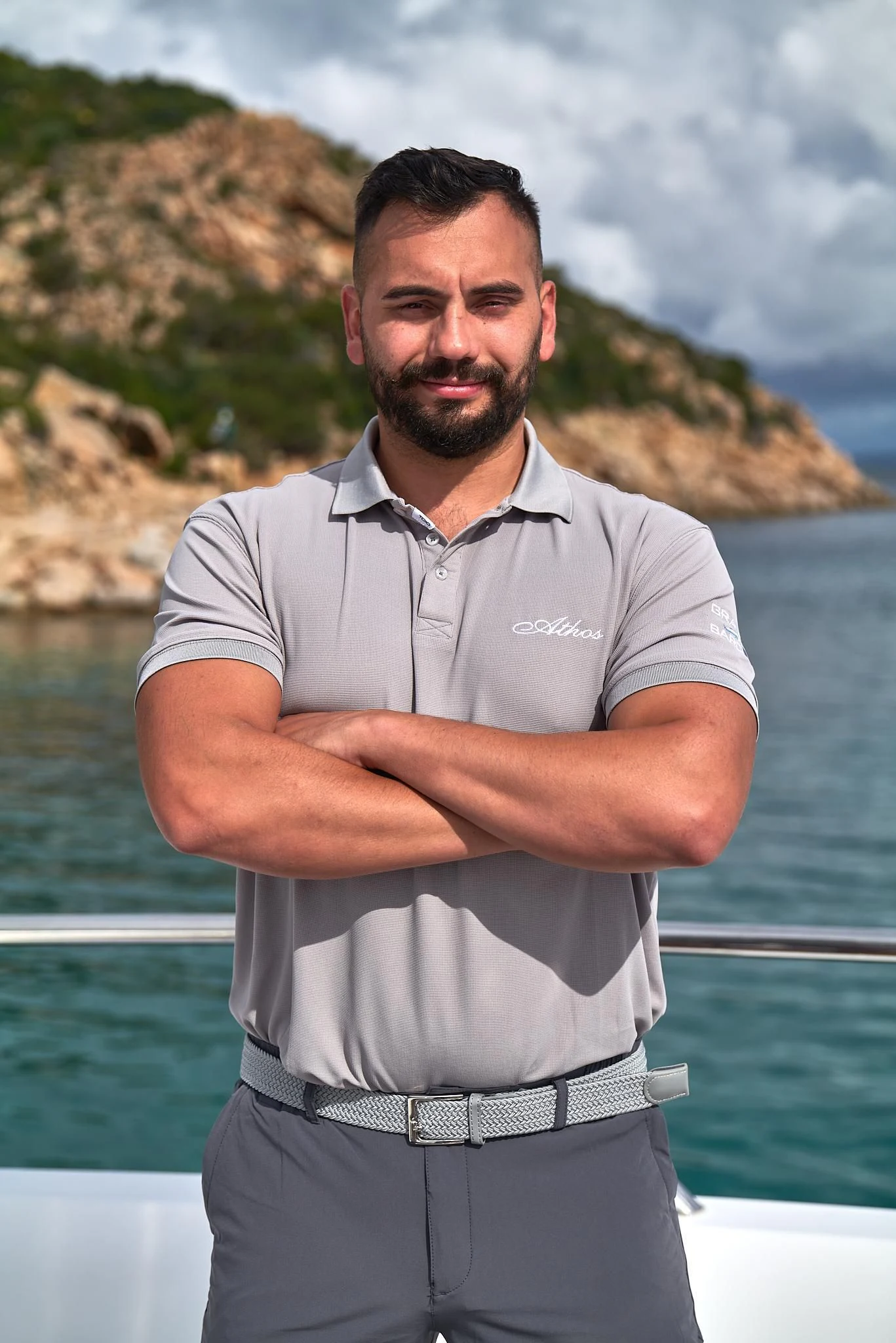 a man standing in front of a body of water aboard ATHOS Yacht for Sale
