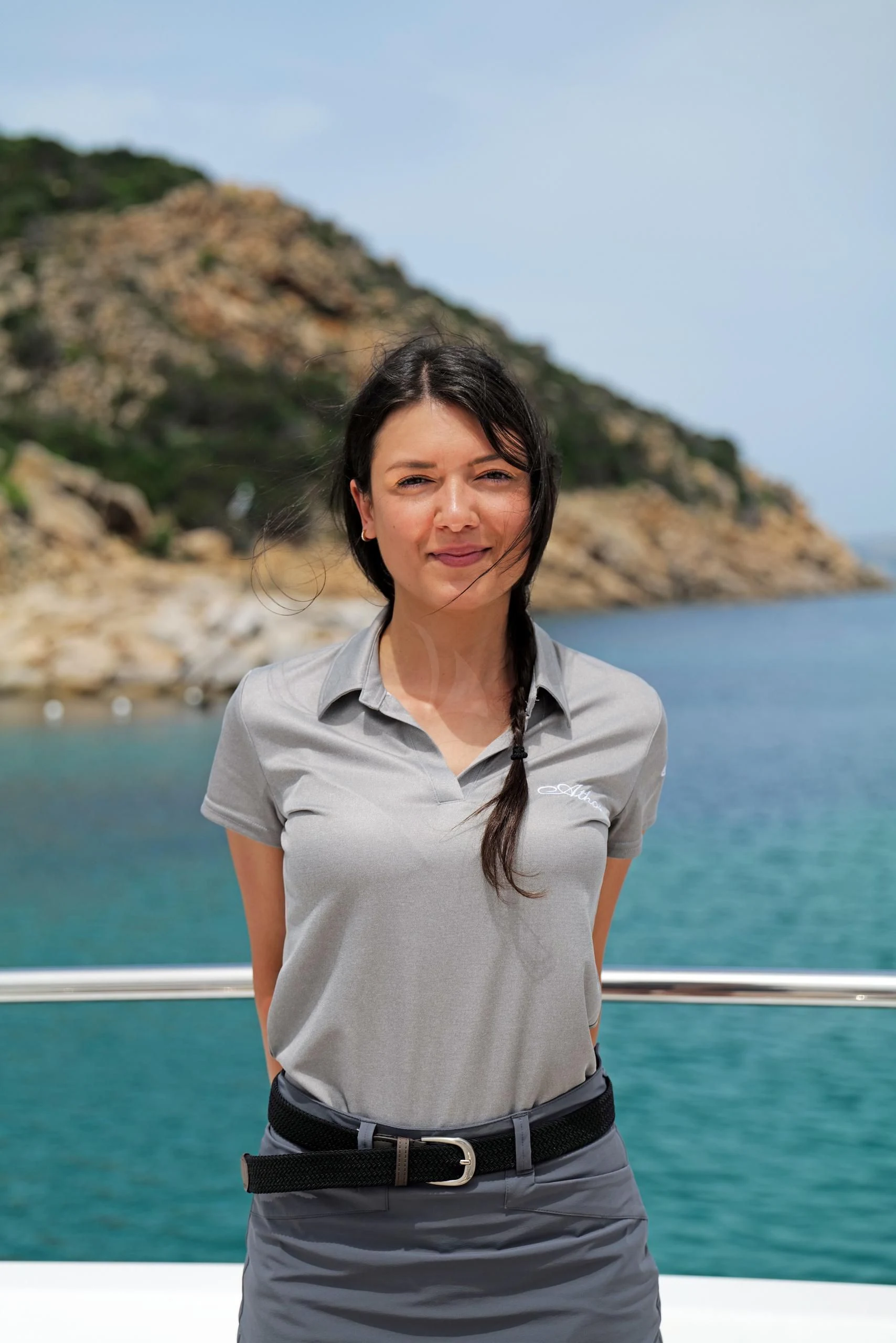 a woman standing in front of a body of water aboard ATHOS Yacht for Sale