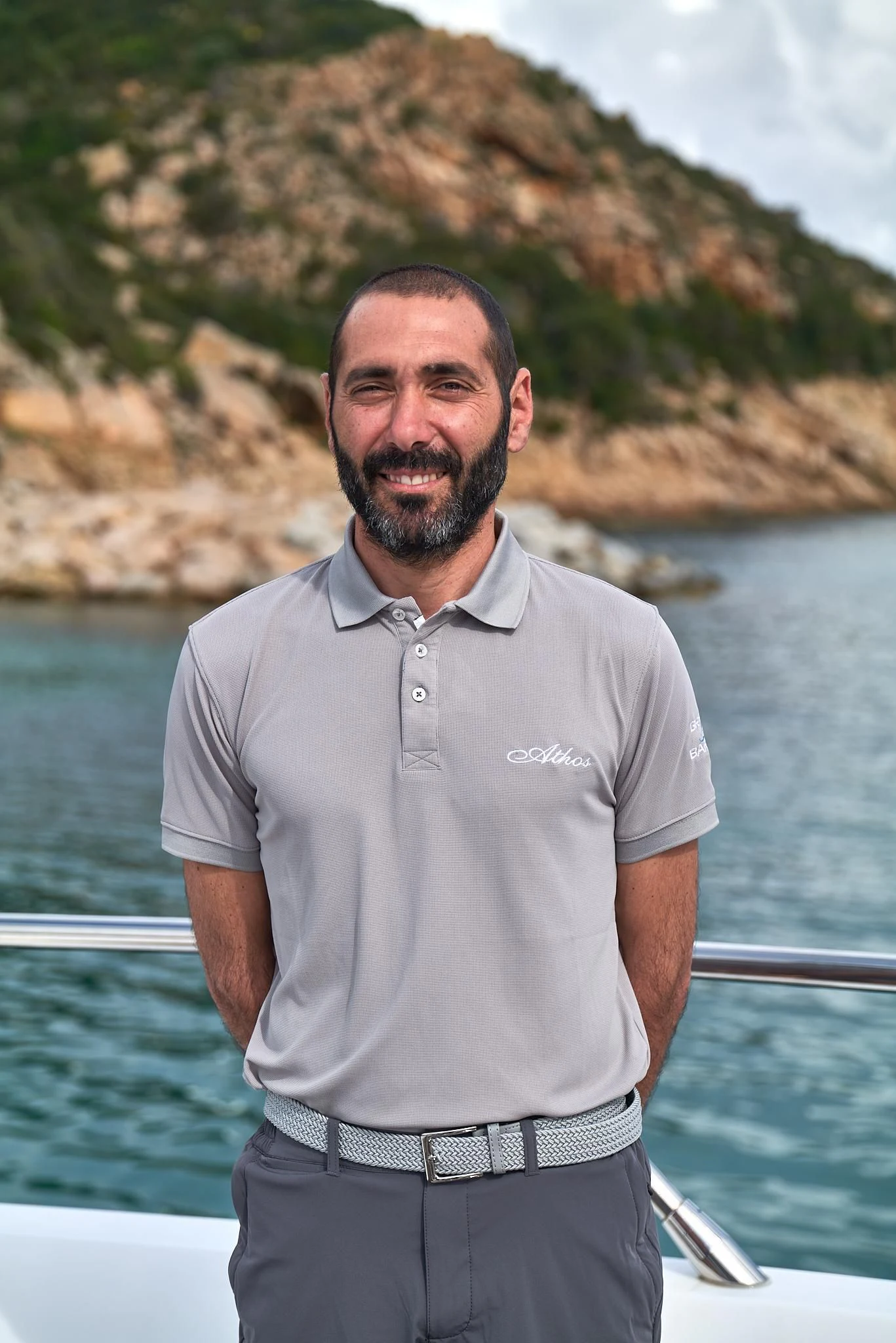 a man standing in front of a body of water aboard ATHOS Yacht for Sale