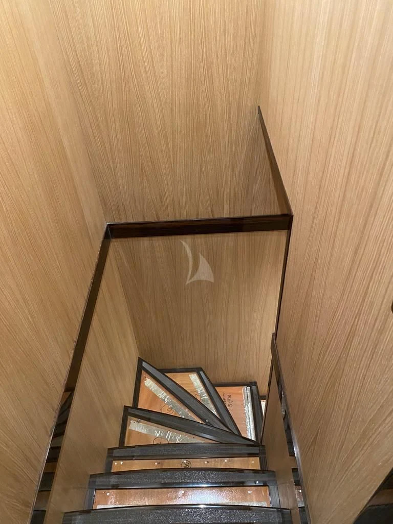 a wooden staircase with a piano aboard ATHOS Yacht for Sale