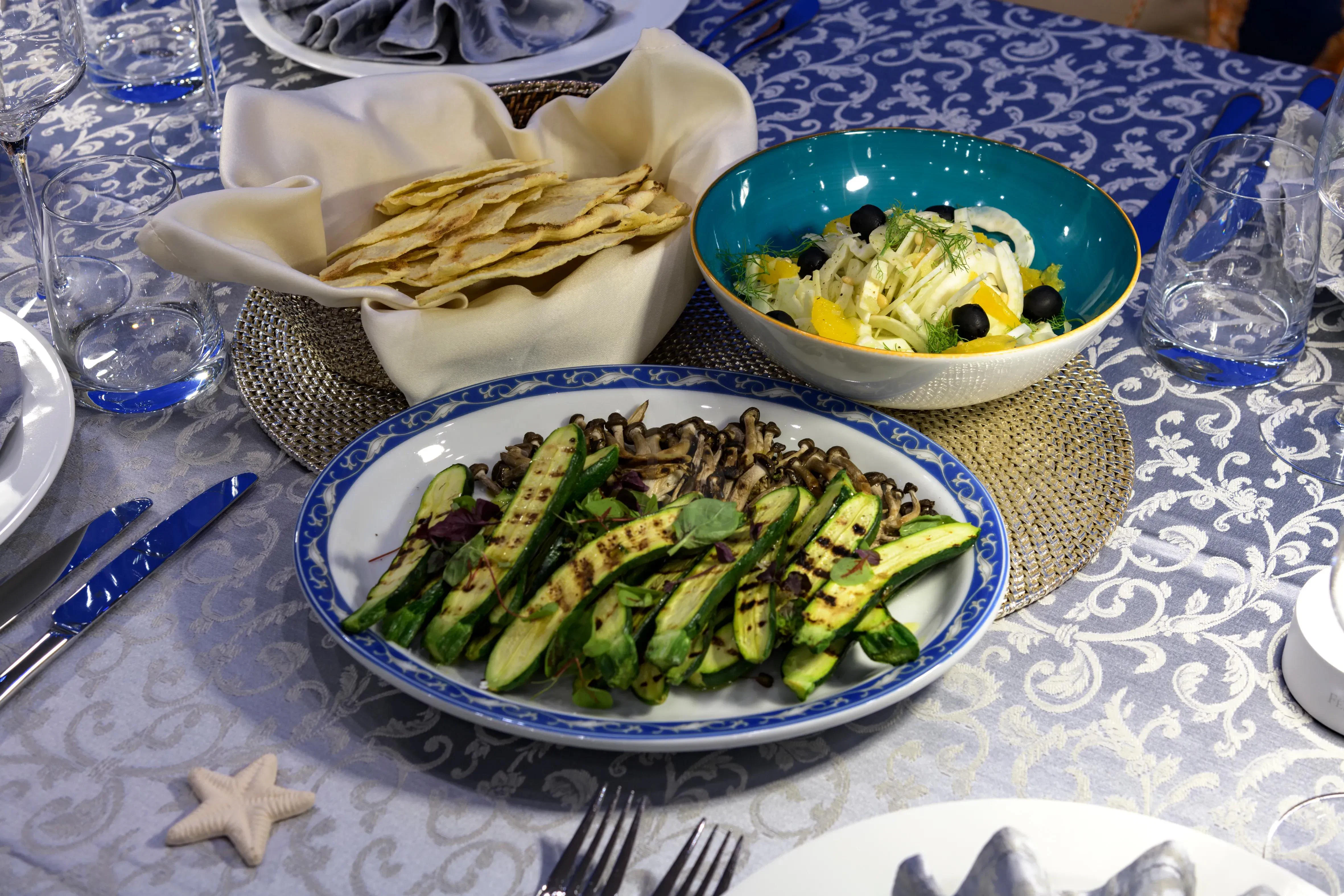 a table with plates of food aboard ATHOS Yacht for Sale