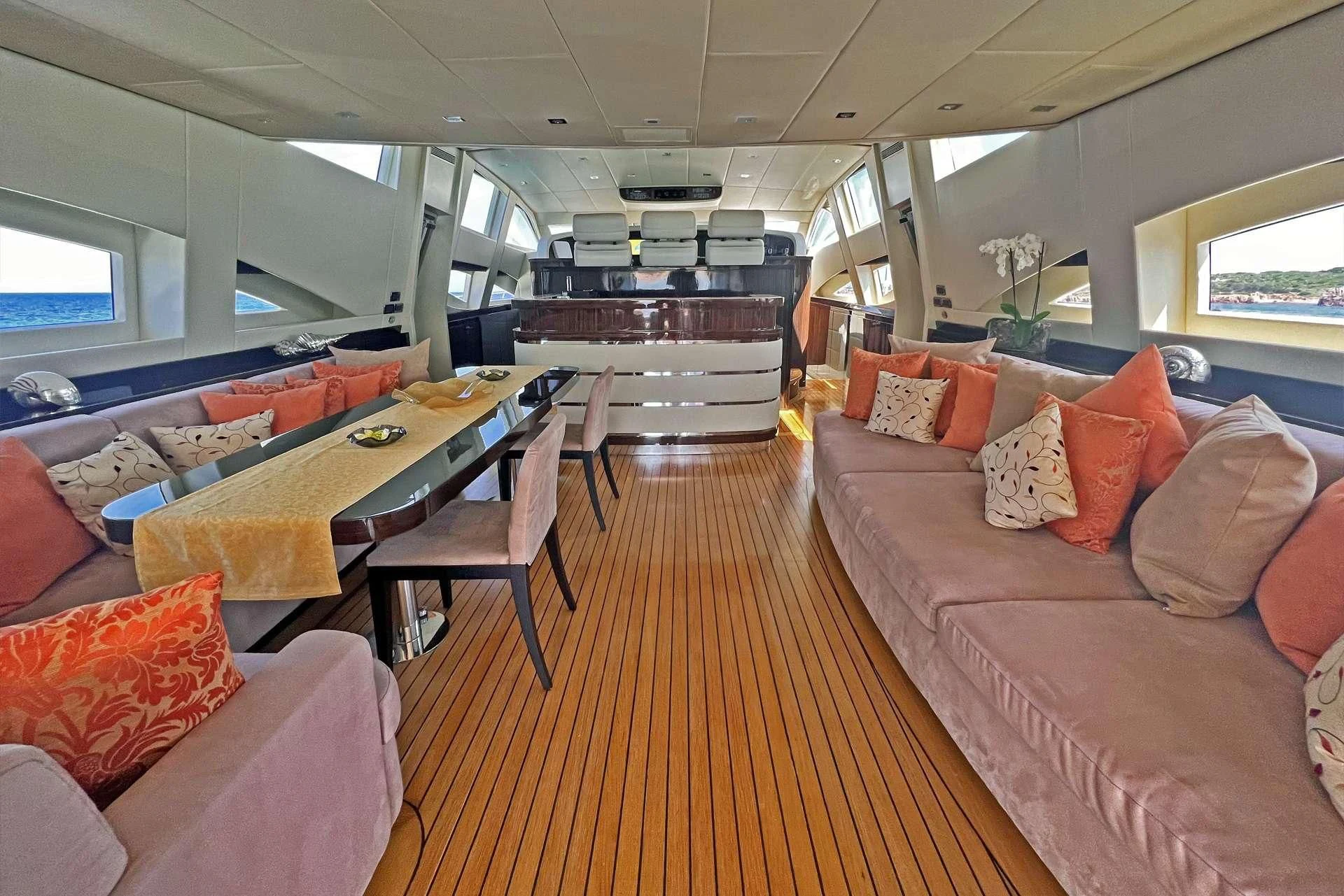 a train with a table and couches aboard ATHOS Yacht for Sale