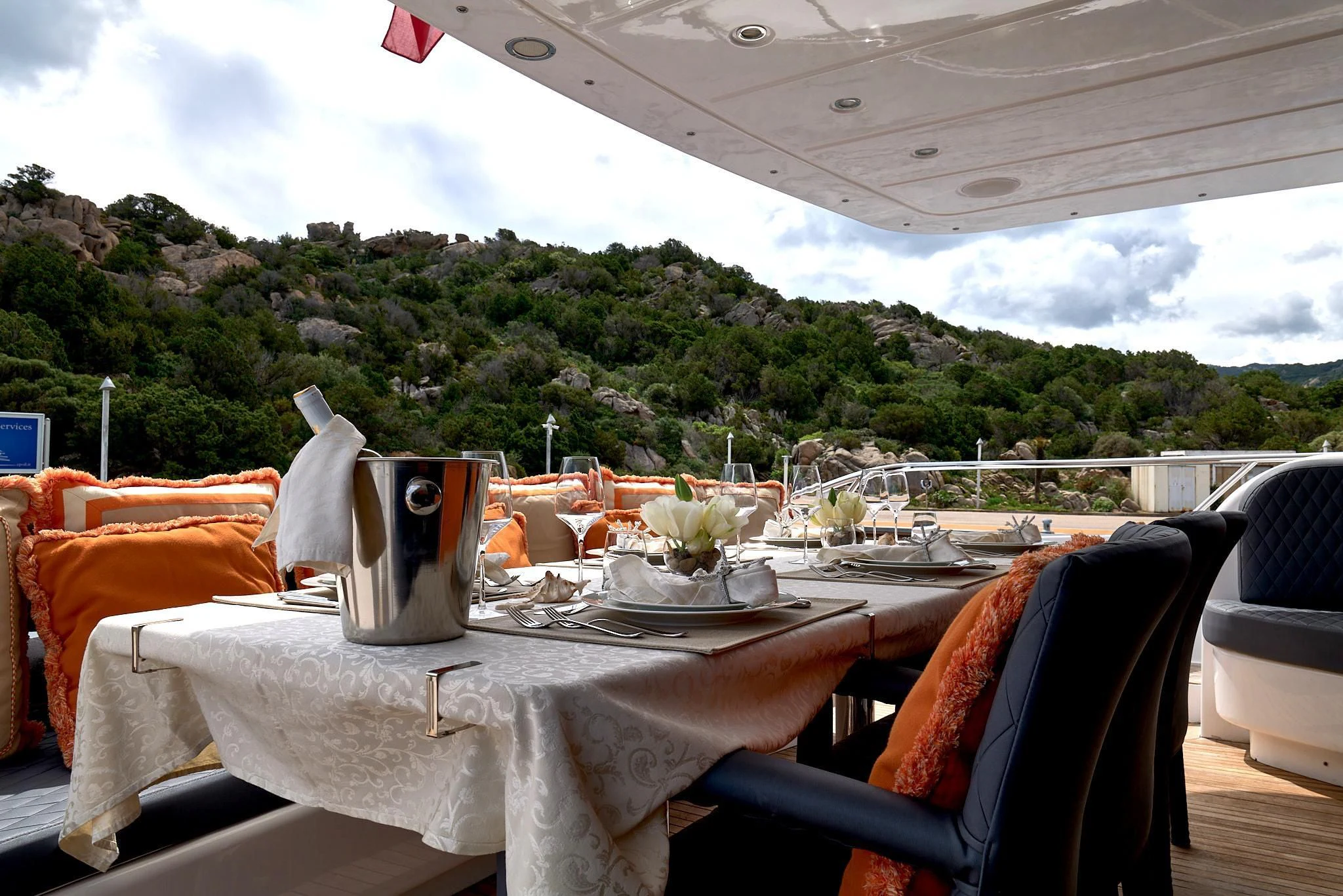 a table with a set of chairs and a large white table with a white cloth and a large aboard ATHOS Yacht for Sale