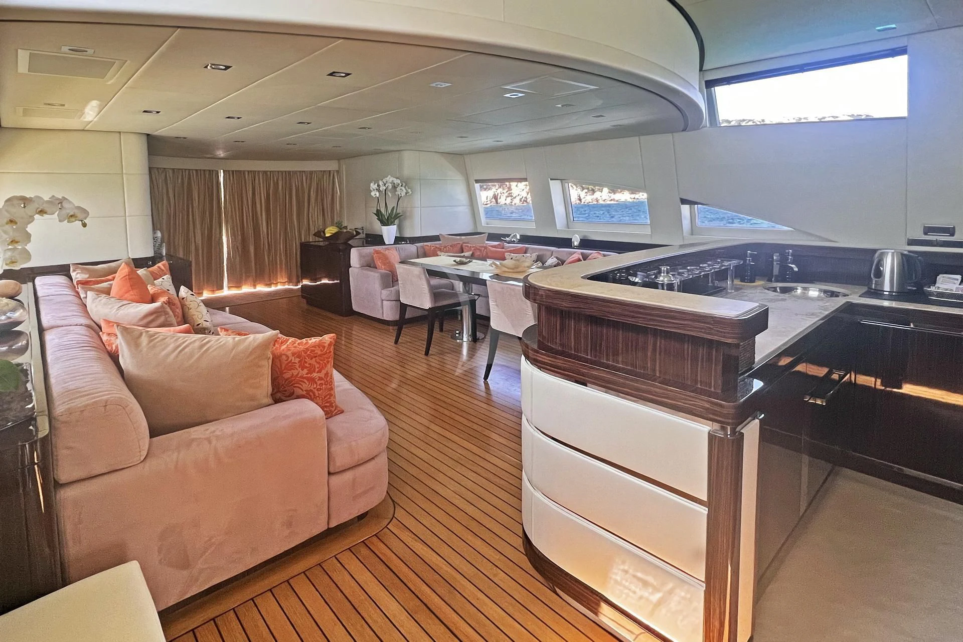 a living room with a couch and a large window aboard ATHOS Yacht for Sale