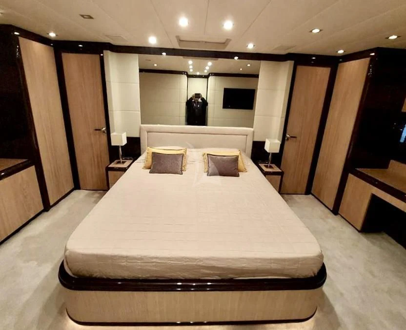 a large bed in a hotel room aboard ATHOS Yacht for Sale