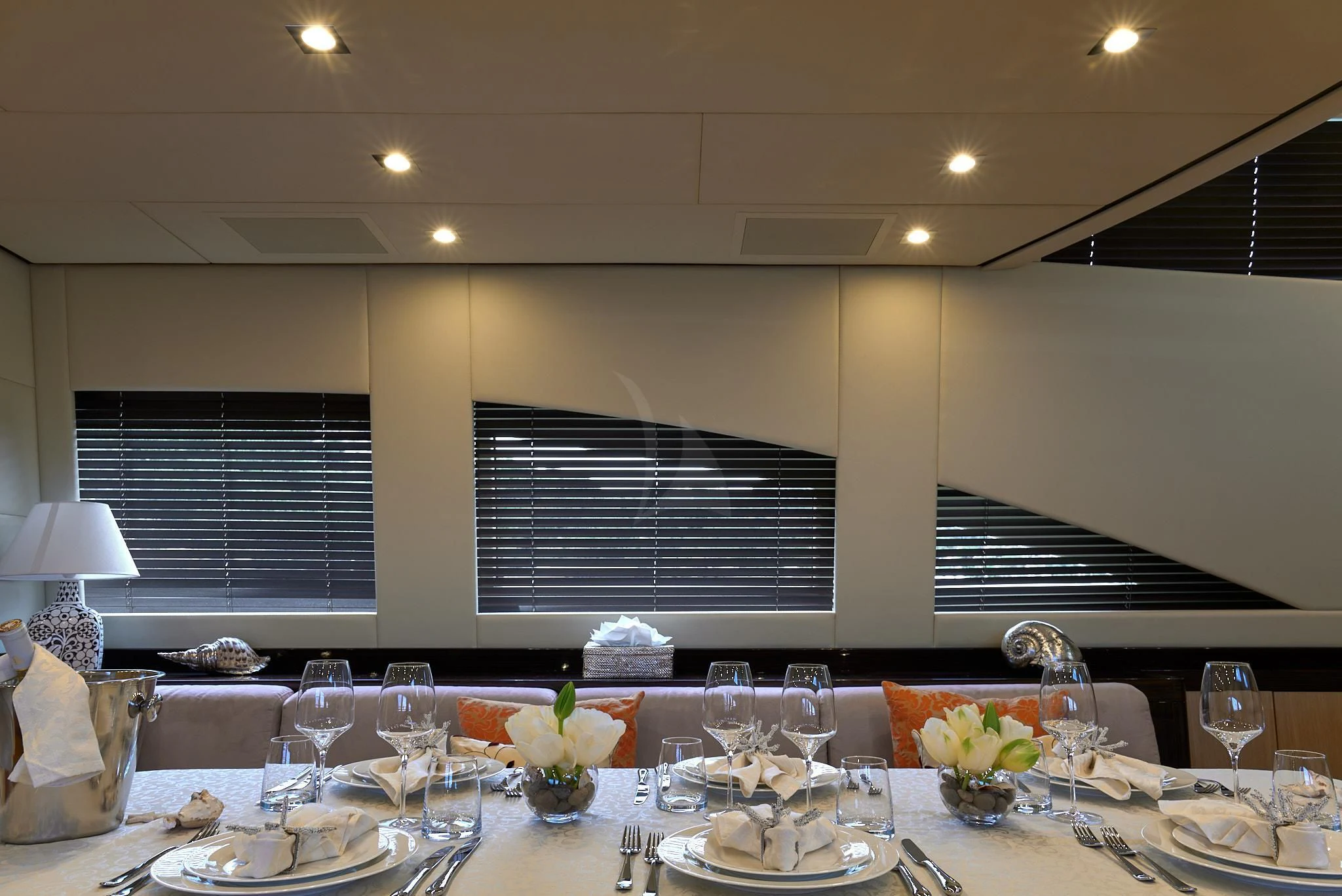 a table with wine glasses and plates aboard ATHOS Yacht for Sale