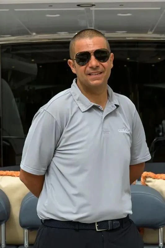 a man wearing sunglasses aboard ATHOS Yacht for Sale