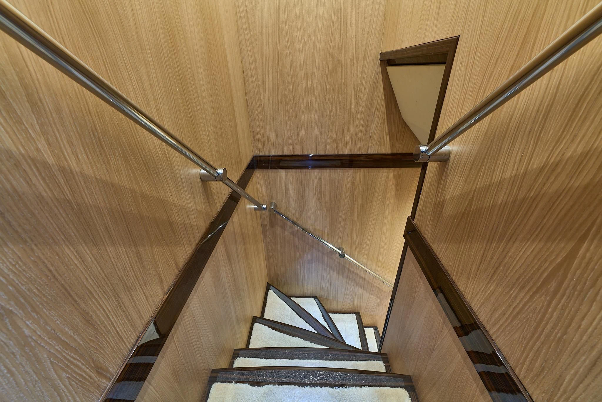 a staircase with a spiral staircase aboard ATHOS Yacht for Sale