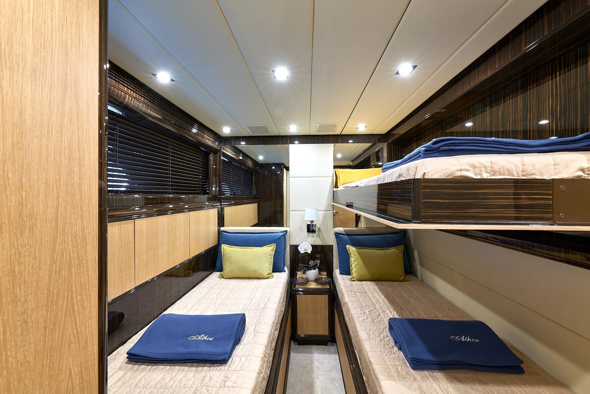 a room with beds and a desk aboard ATHOS Yacht for Sale