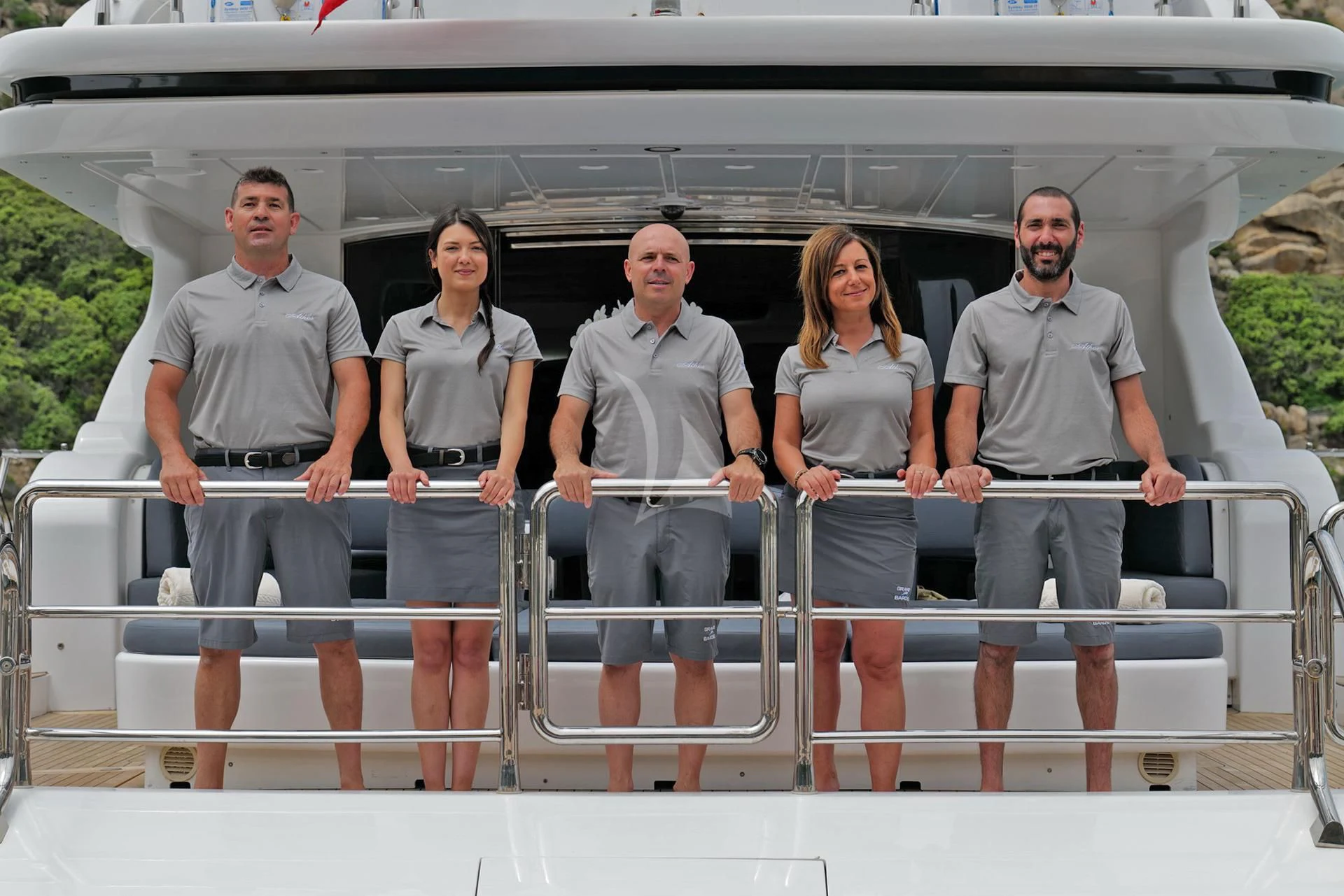 a group of people standing on a balcony aboard ATHOS Yacht for Sale