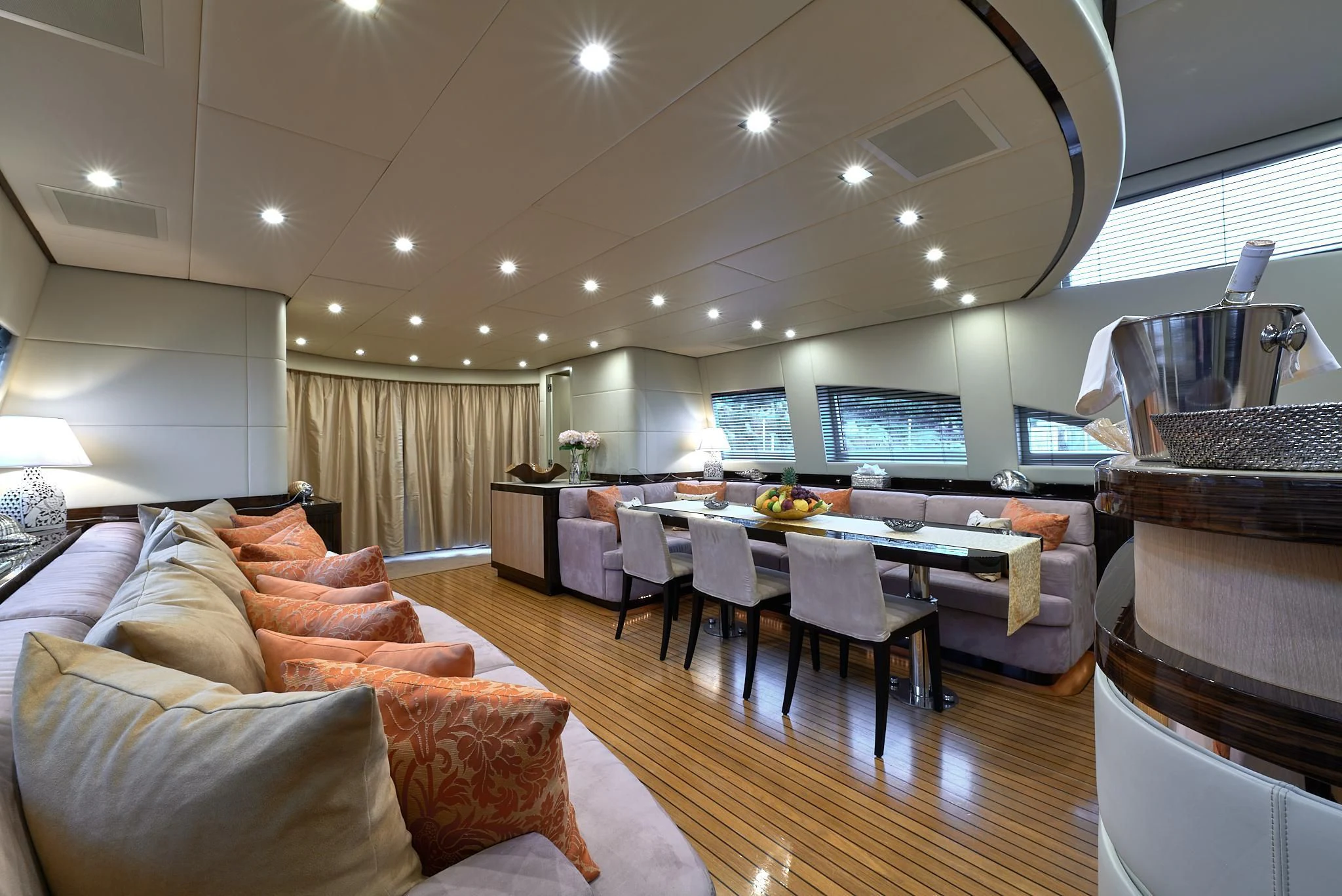 a living room with a large table and couches aboard ATHOS Yacht for Sale