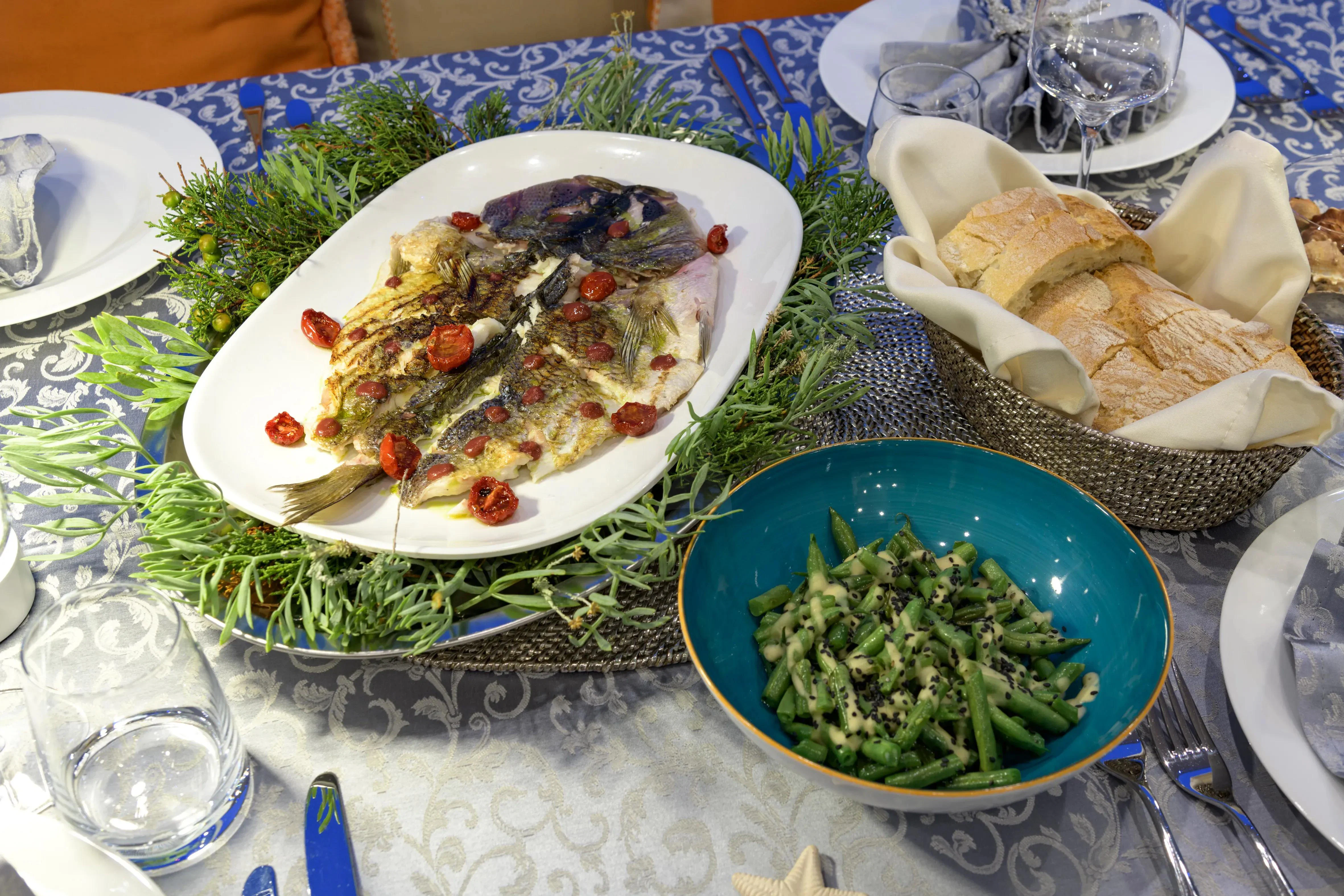 a table with plates of food and bowls of food aboard ATHOS Yacht for Sale