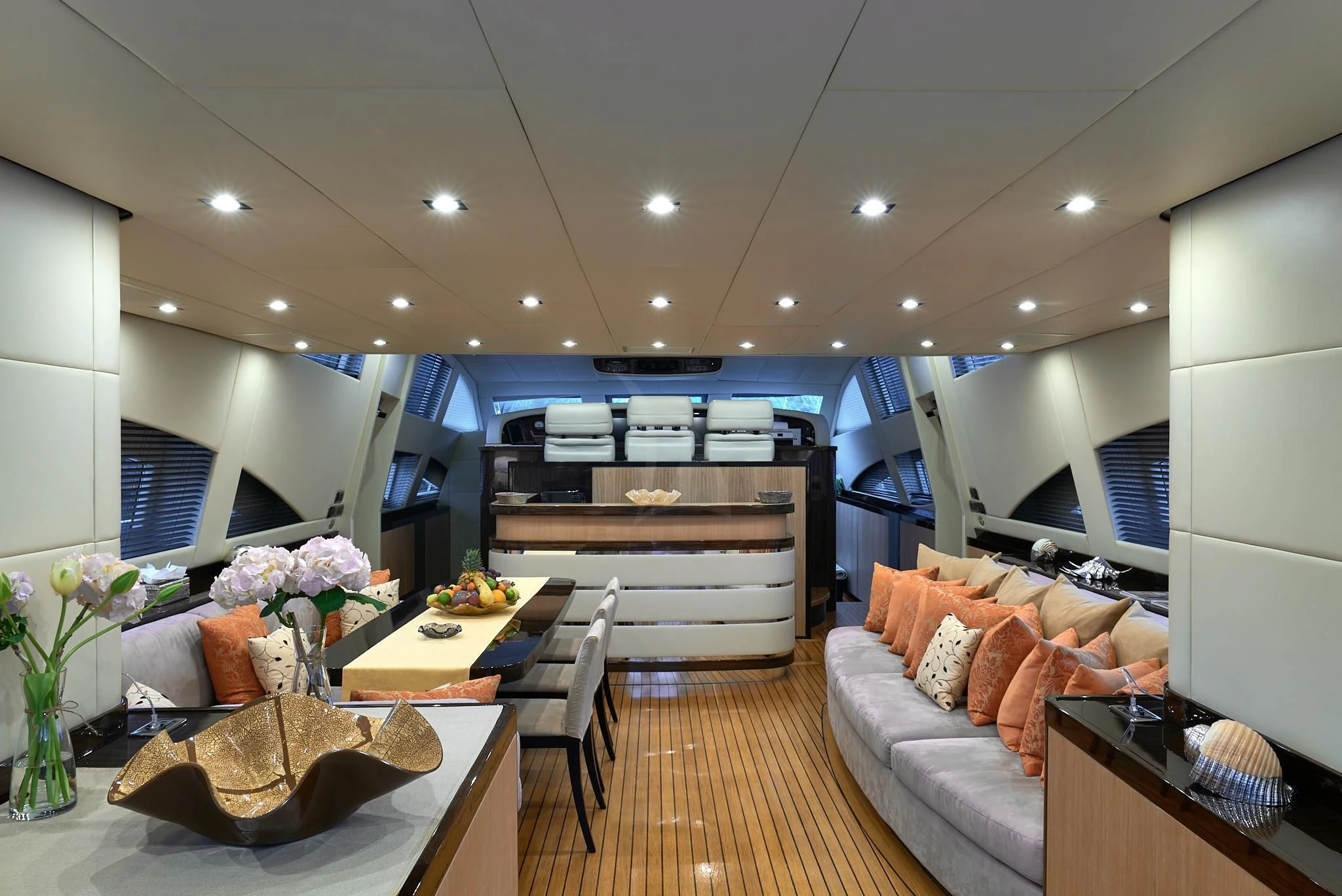 a living room with a wood table and couches aboard ATHOS Yacht for Sale