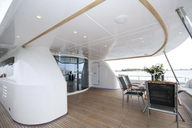 a room with a table and chairs aboard NASER II Yacht for Sale