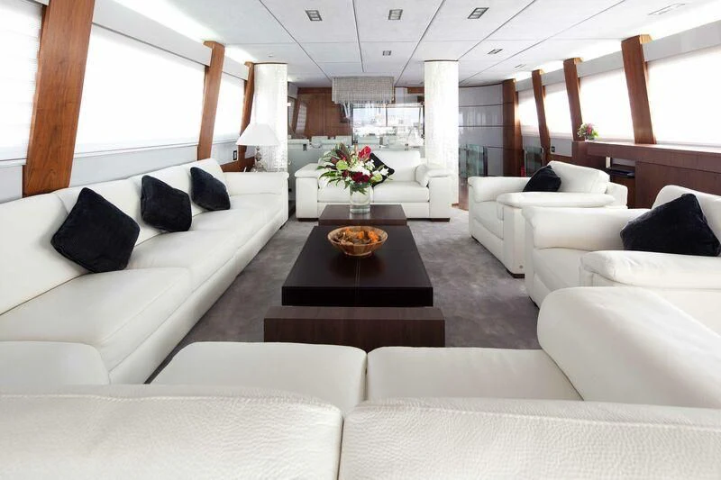 a living room with white couches aboard NASER II Yacht for Sale