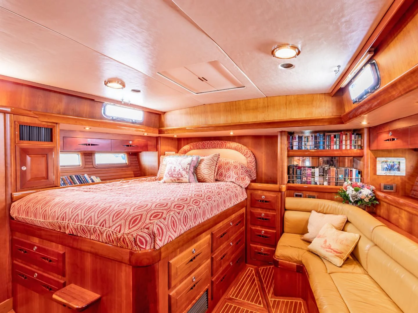 a bedroom with a bed and a couch aboard WILD THING Yacht for Sale