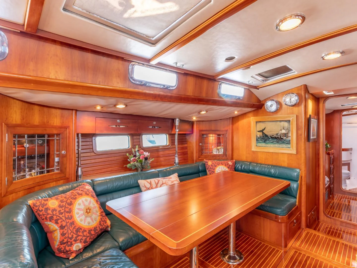 a living room with a table and couches aboard WILD THING Yacht for Sale