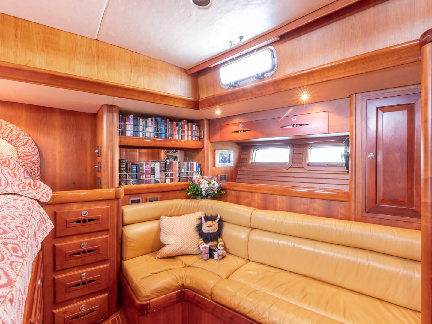 a room with a couch and a book shelf aboard WILD THING Yacht for Sale