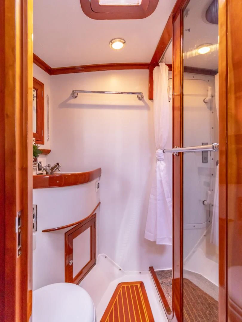 a bathroom with a shower and sink aboard WILD THING Yacht for Sale