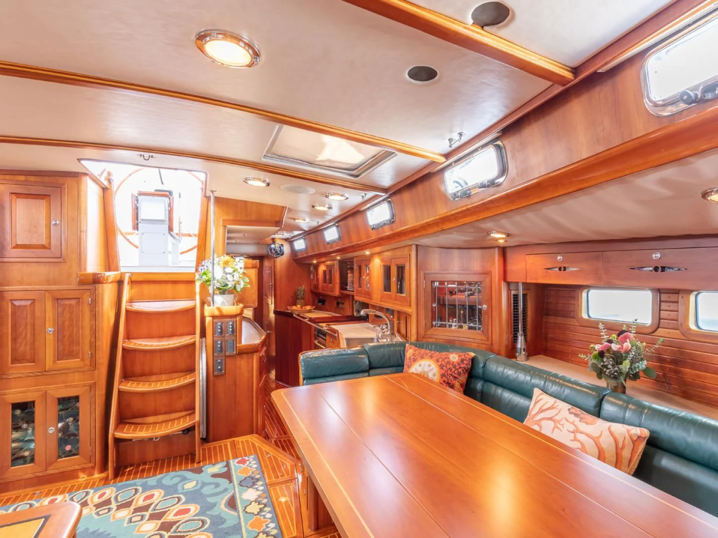 a room with a wood table and a staircase aboard WILD THING Yacht for Sale