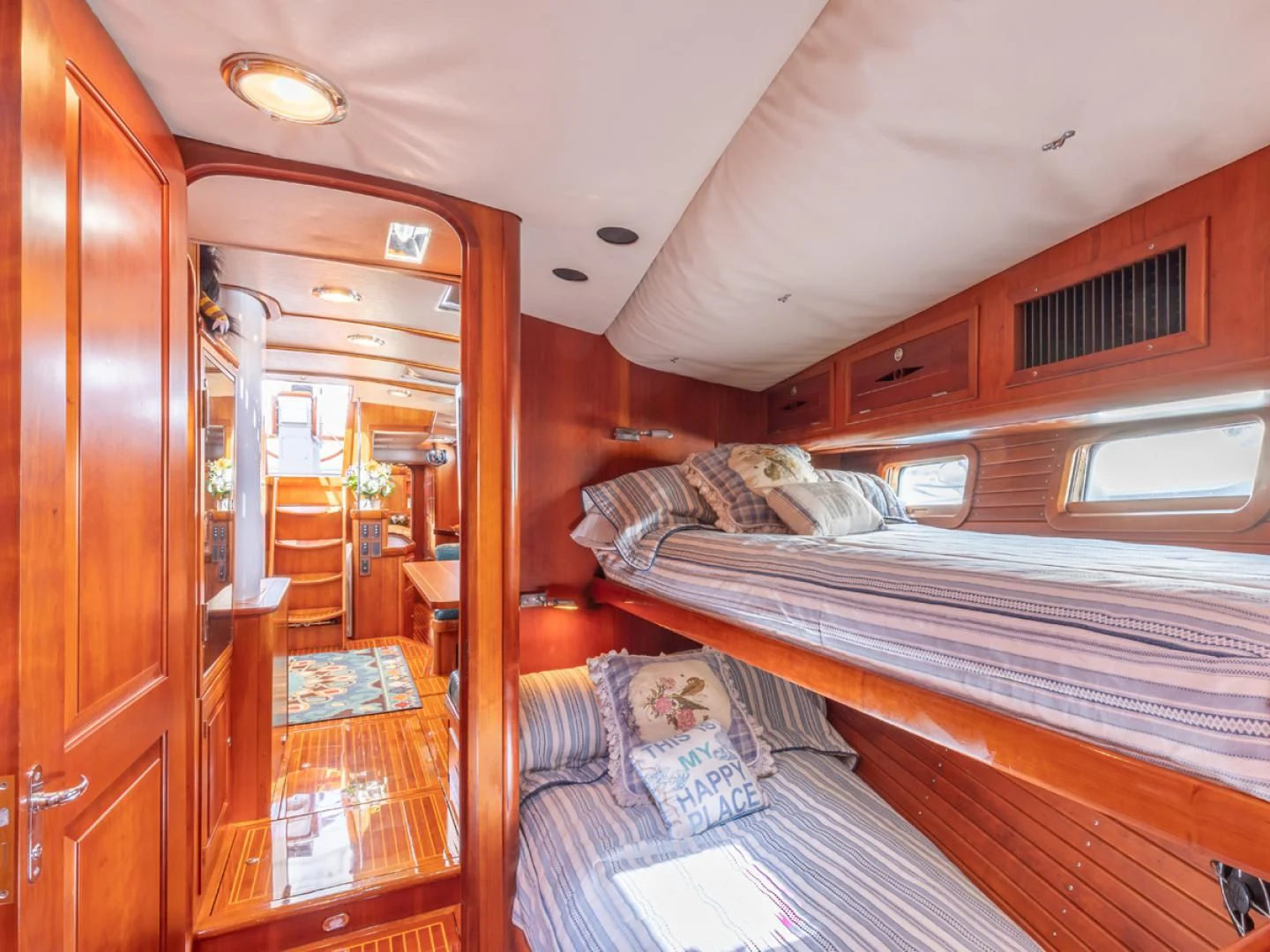 a bedroom with a bed and a closet aboard WILD THING Yacht for Sale