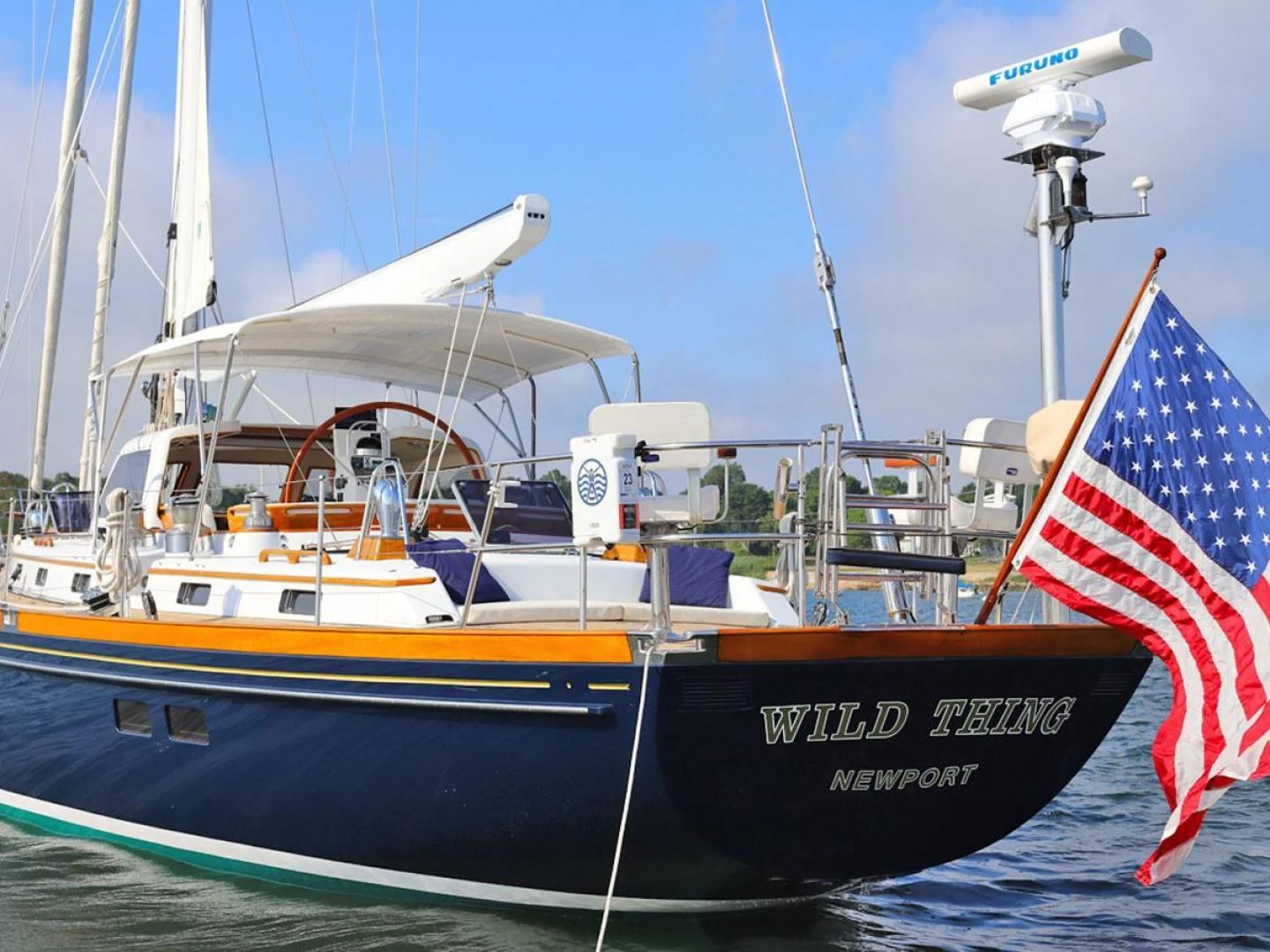 a boat with a flag on the front aboard WILD THING Yacht for Sale