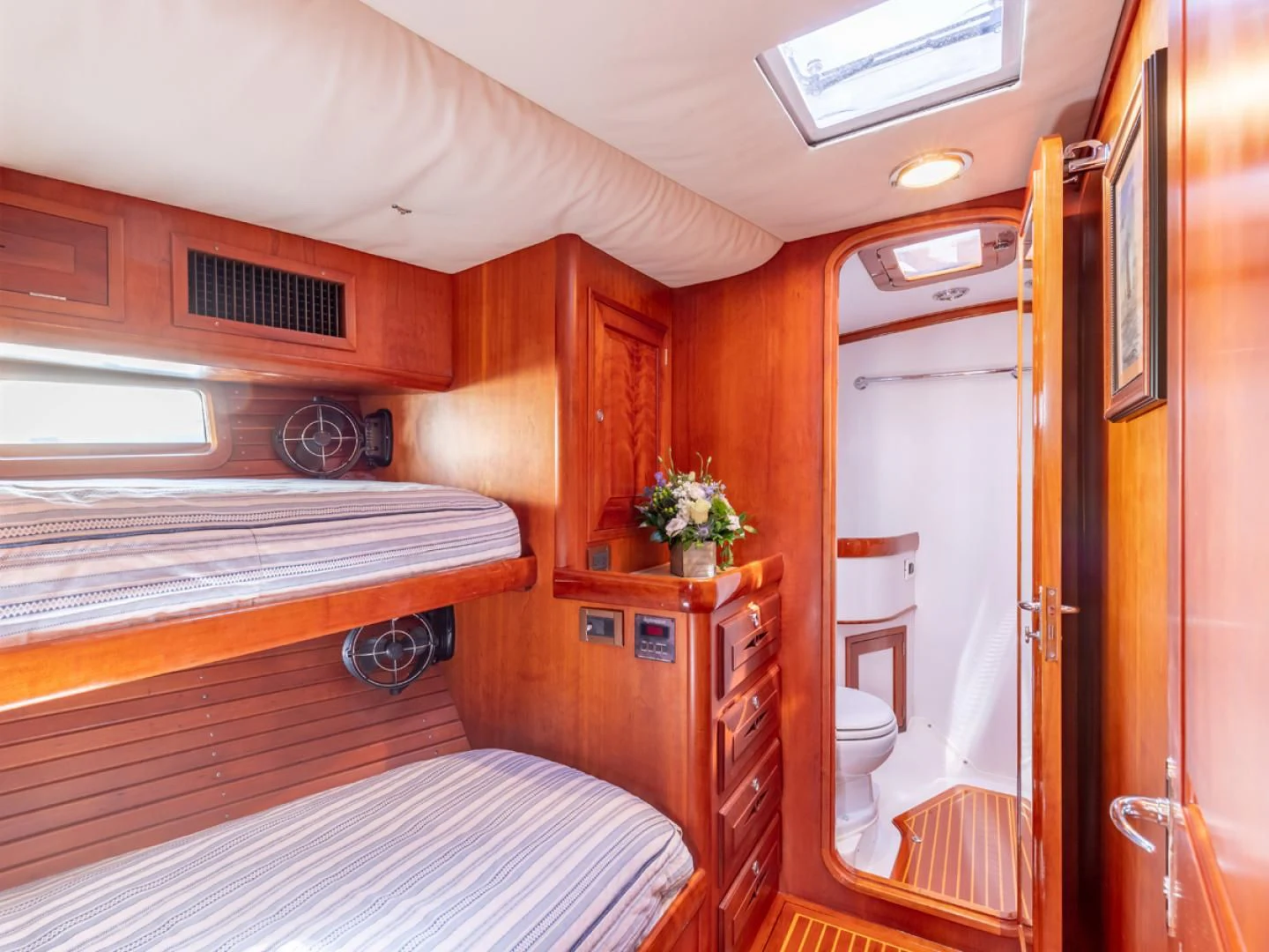 a bedroom with a bed and a closet aboard WILD THING Yacht for Sale