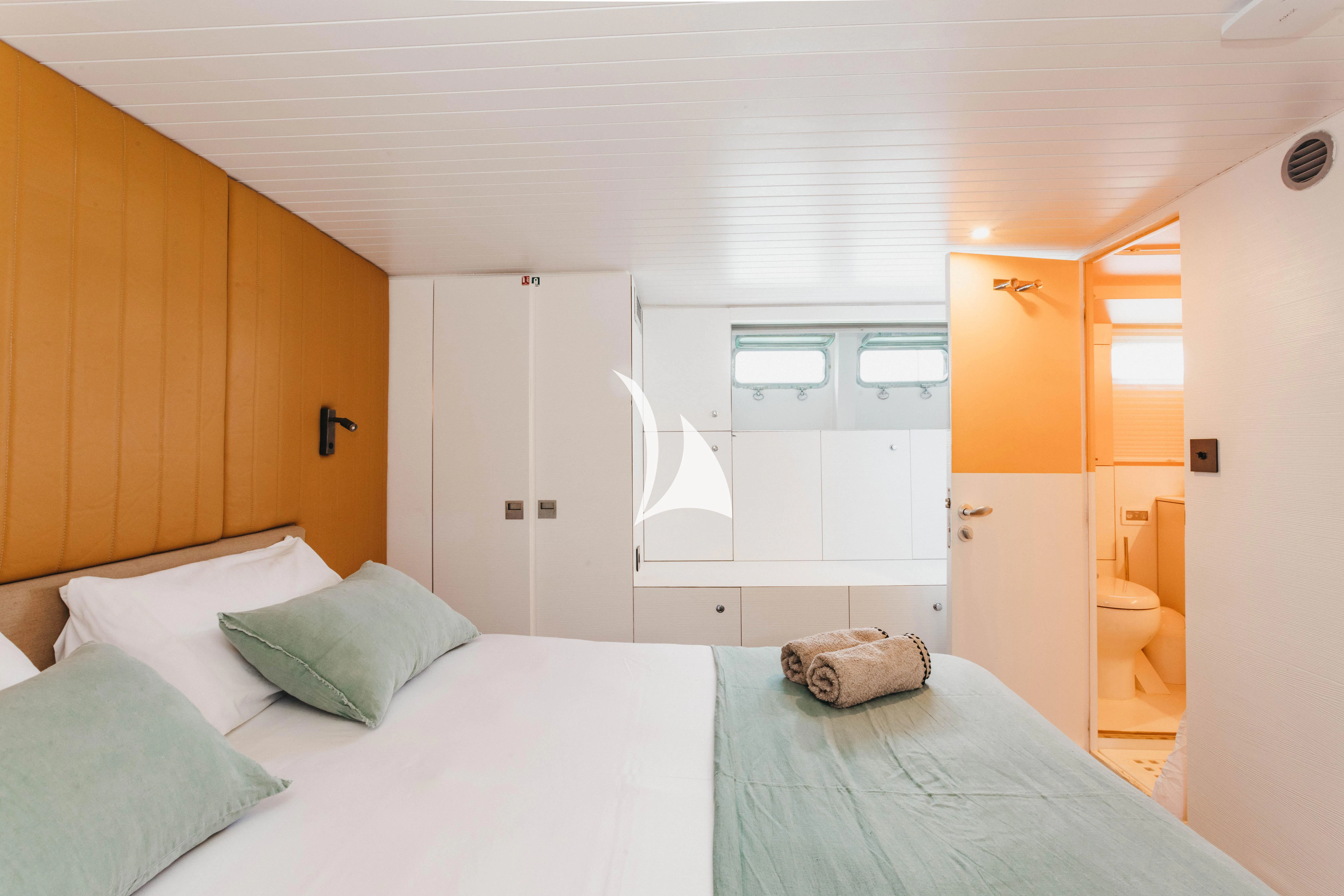 a bedroom with a bed and a mirror aboard CIUTADELLA Yacht for Sale