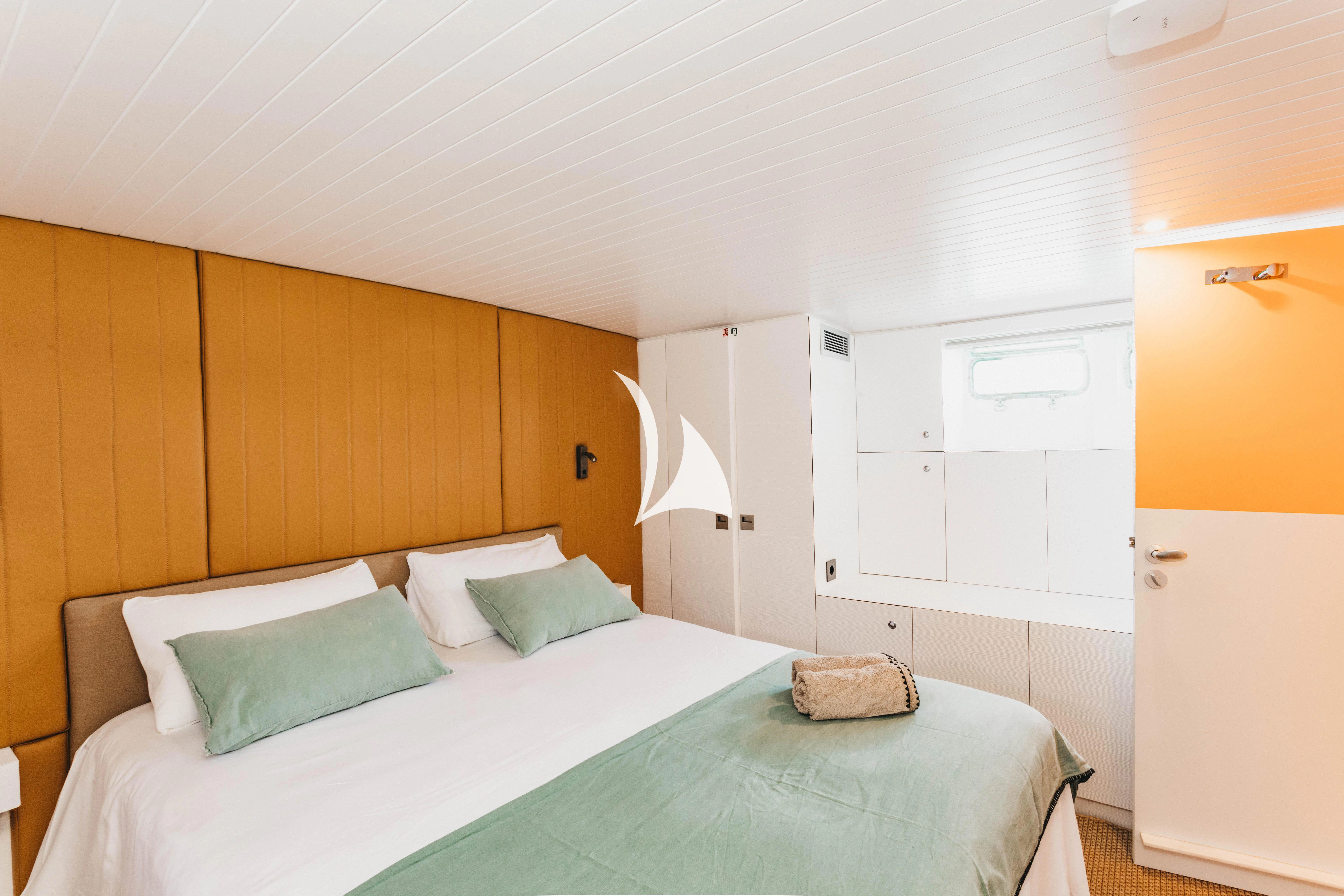 a bedroom with a bed and a closet aboard CIUTADELLA Yacht for Sale
