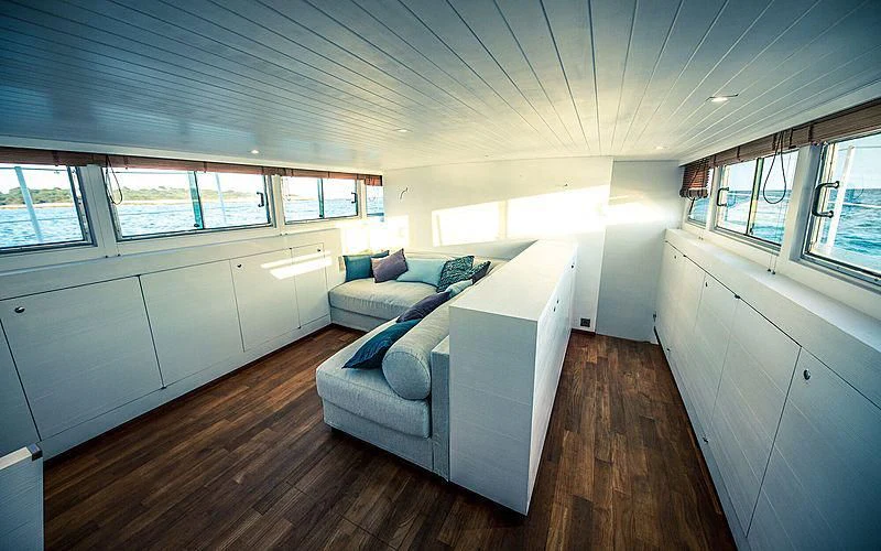 a living room with a couch aboard CIUTADELLA Yacht for Sale