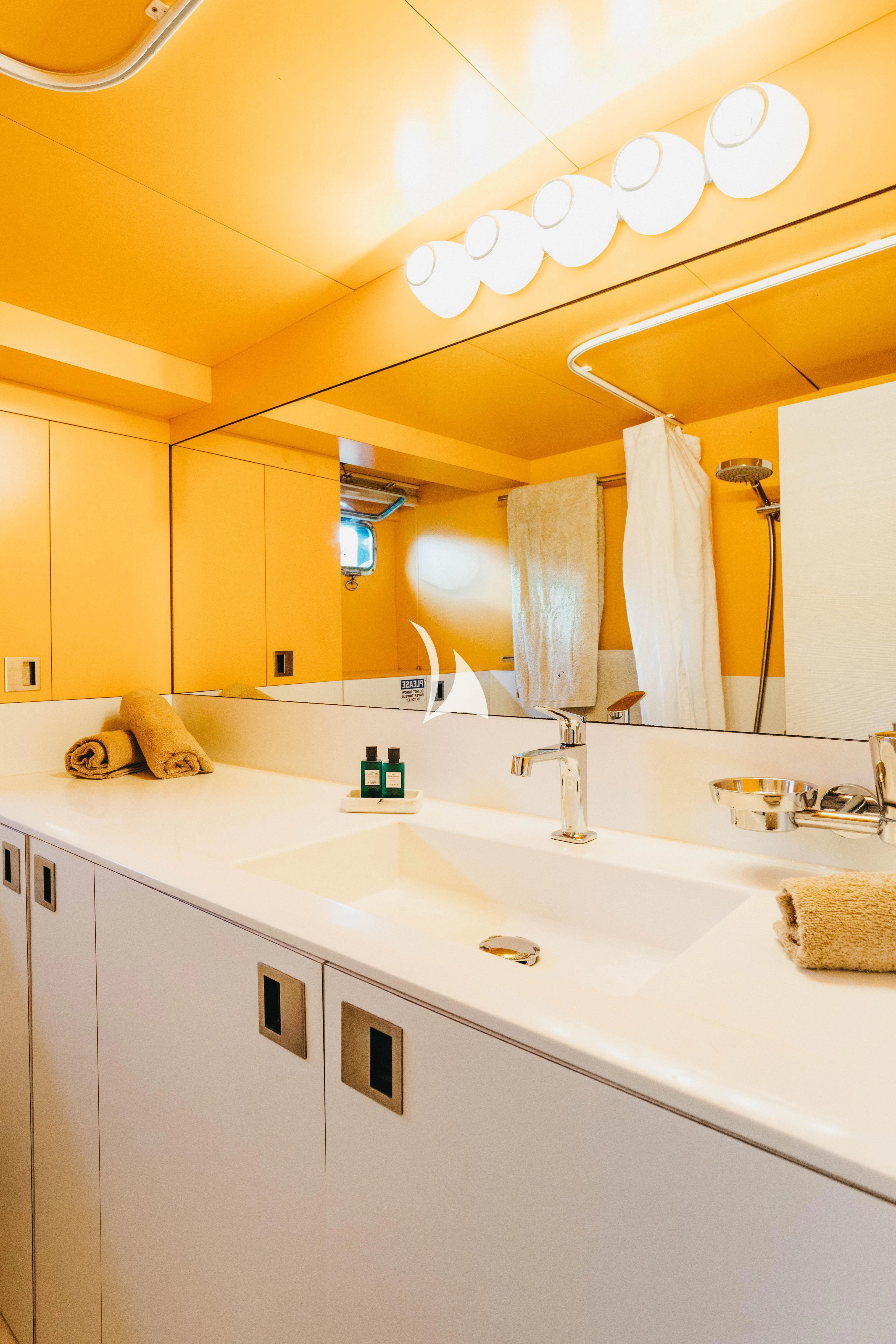 a bathroom with a large mirror aboard CIUTADELLA Yacht for Sale