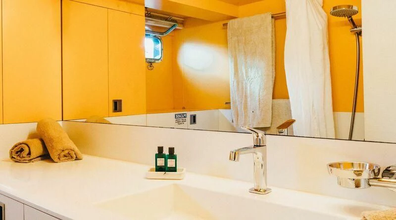 a bathroom with a large mirror aboard CIUTADELLA Yacht for Sale