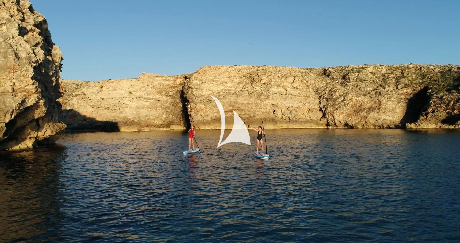 a couple of people on a sailboat in the water aboard CIUTADELLA Yacht for Sale