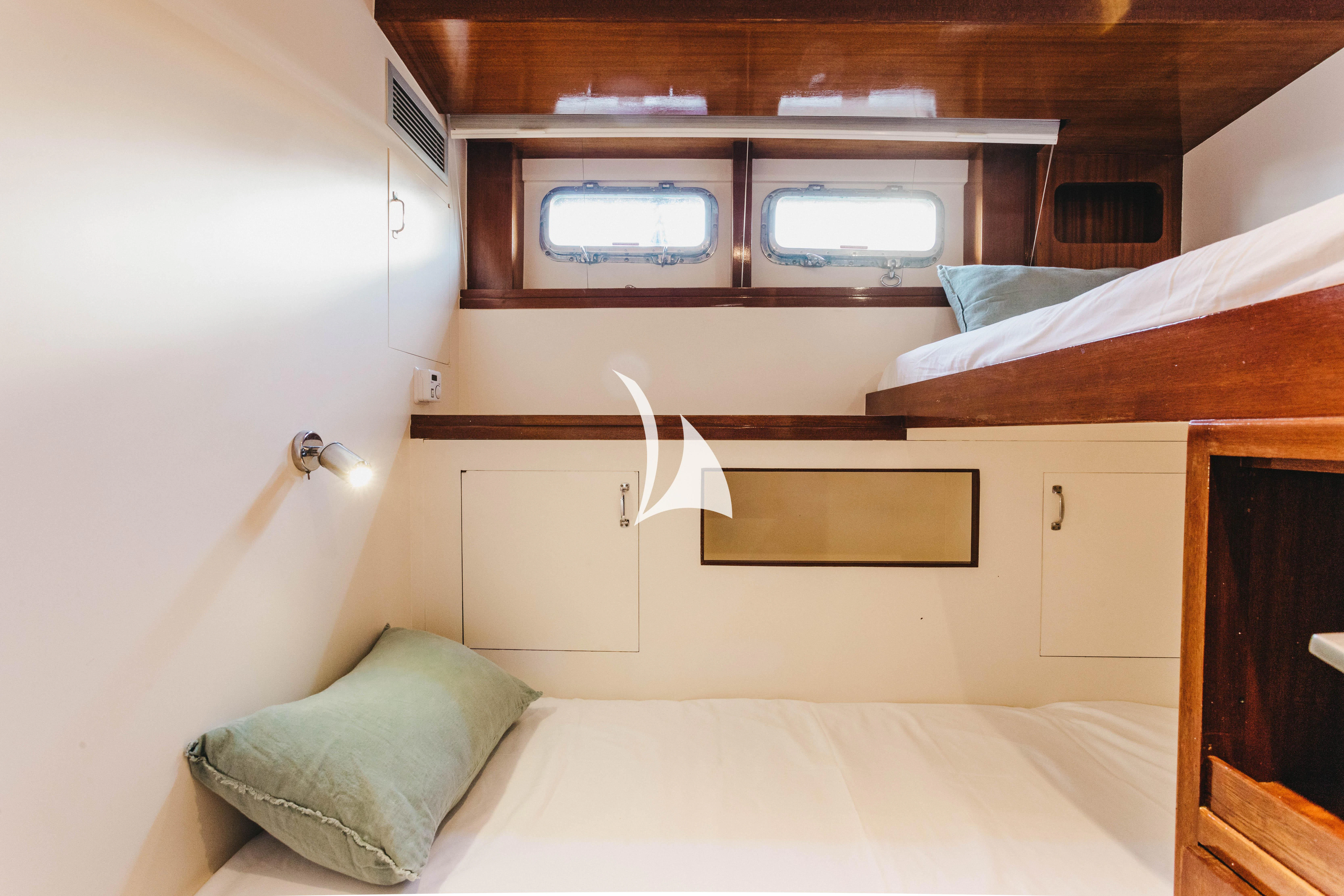 a room with a bed and a television aboard CIUTADELLA Yacht for Sale