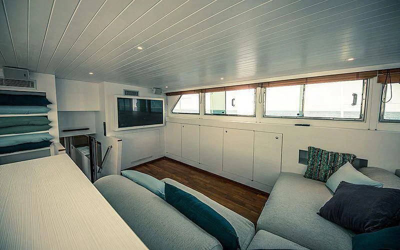 a living room with a couch and a tv aboard CIUTADELLA Yacht for Sale