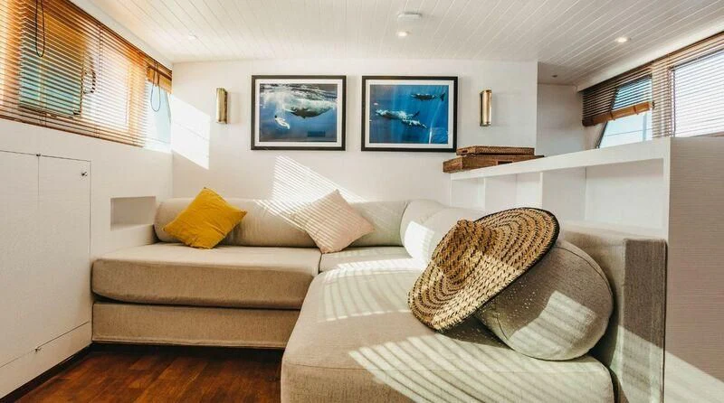 a couch in a room aboard CIUTADELLA Yacht for Sale