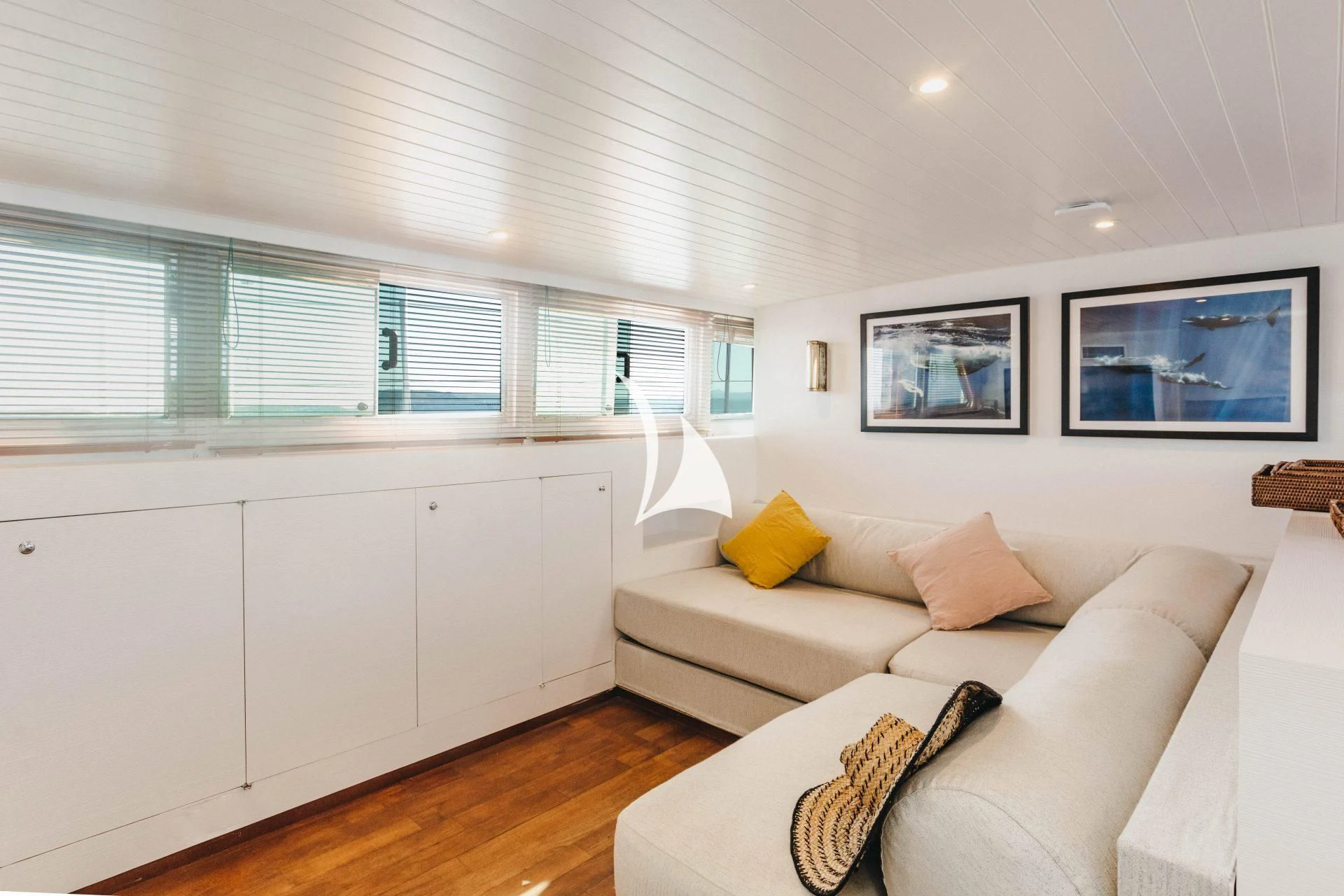 a living room with a couch and a window aboard CIUTADELLA Yacht for Sale