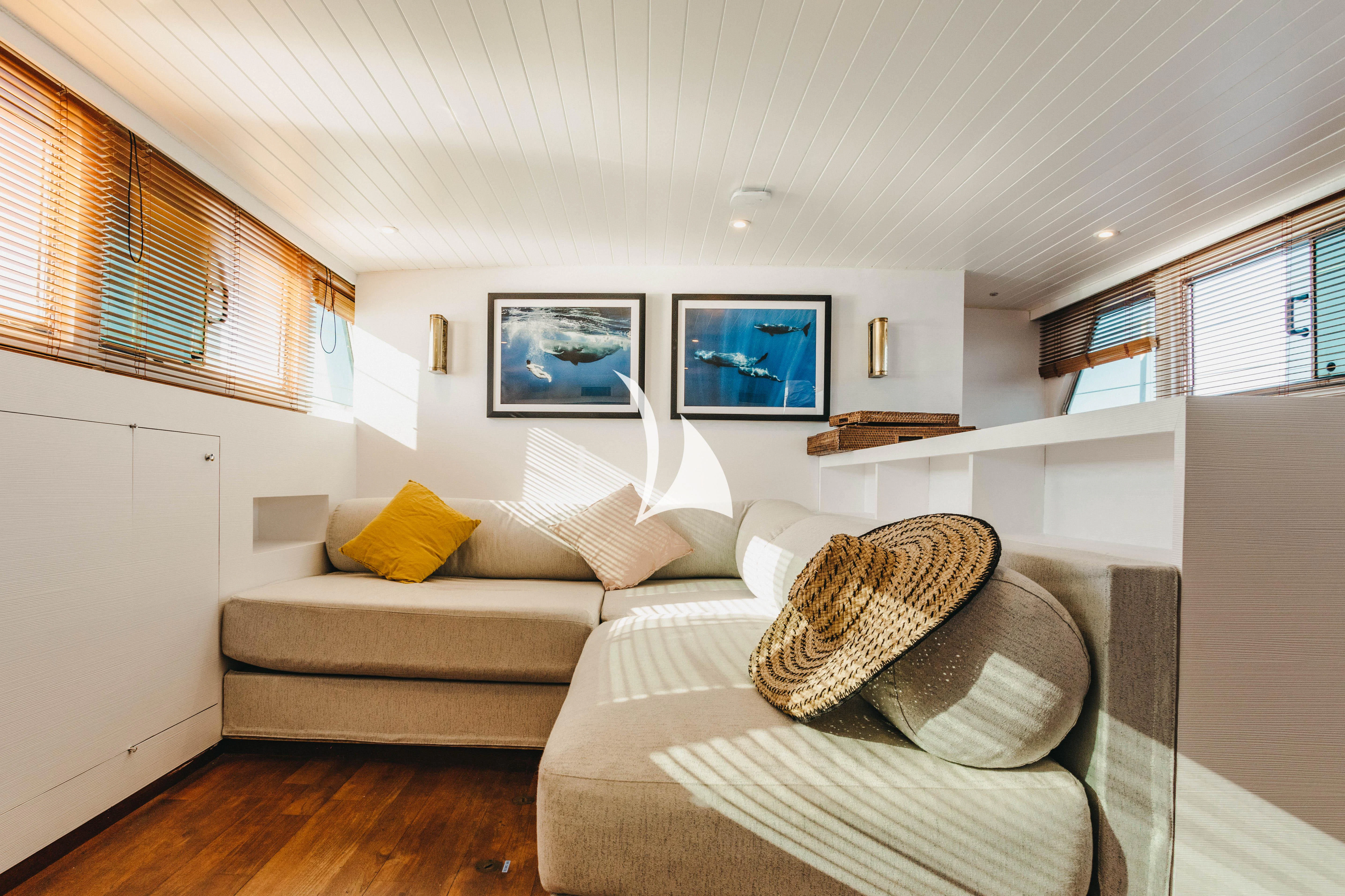 a living room with a couch and a television aboard CIUTADELLA Yacht for Sale