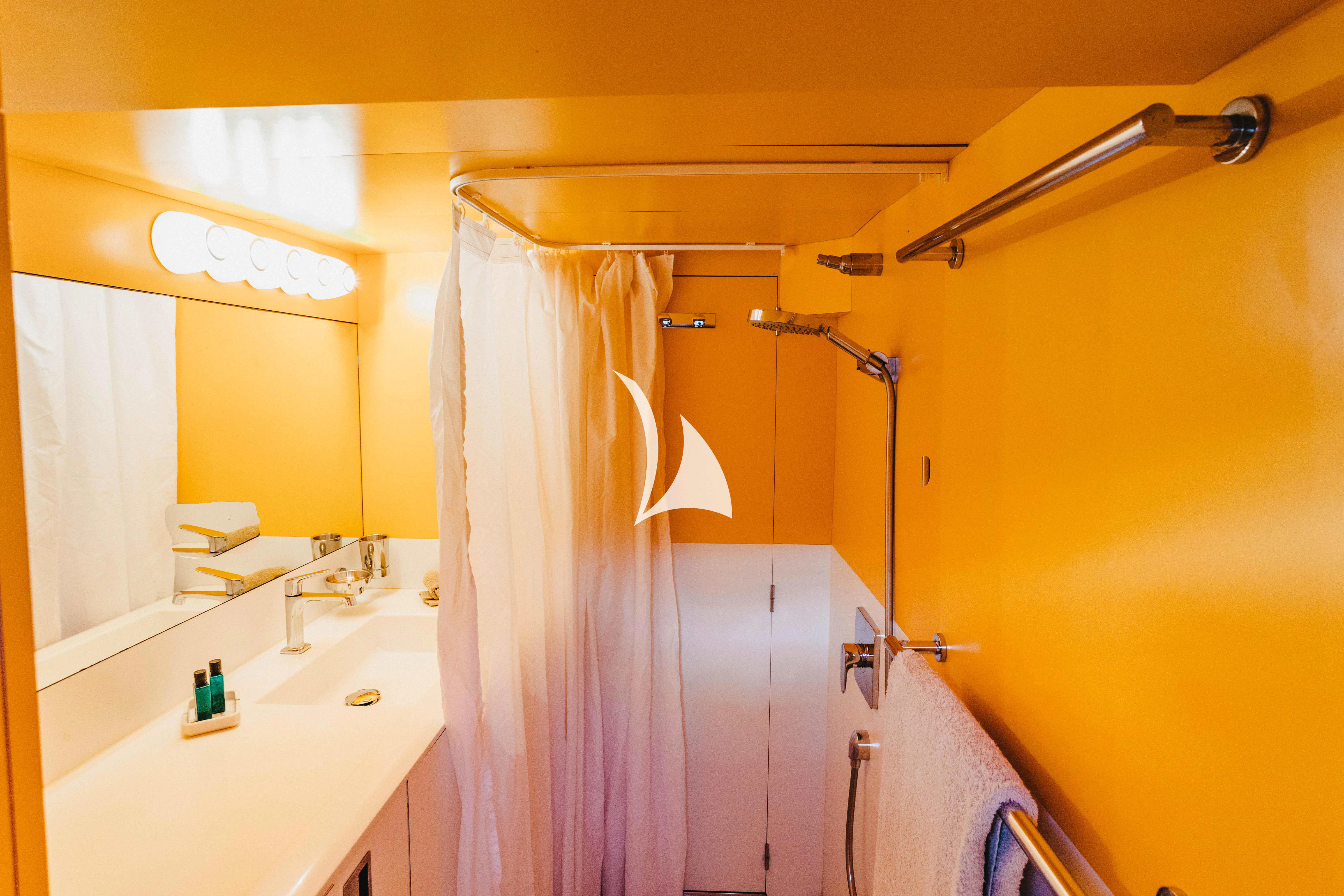 a bathroom with a shower curtain aboard CIUTADELLA Yacht for Sale