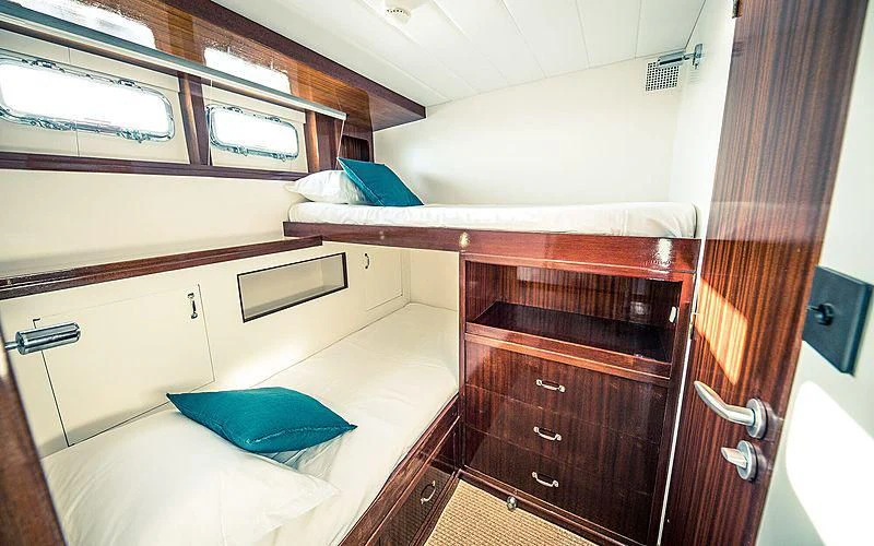 a room with a bed and a dresser aboard CIUTADELLA Yacht for Sale