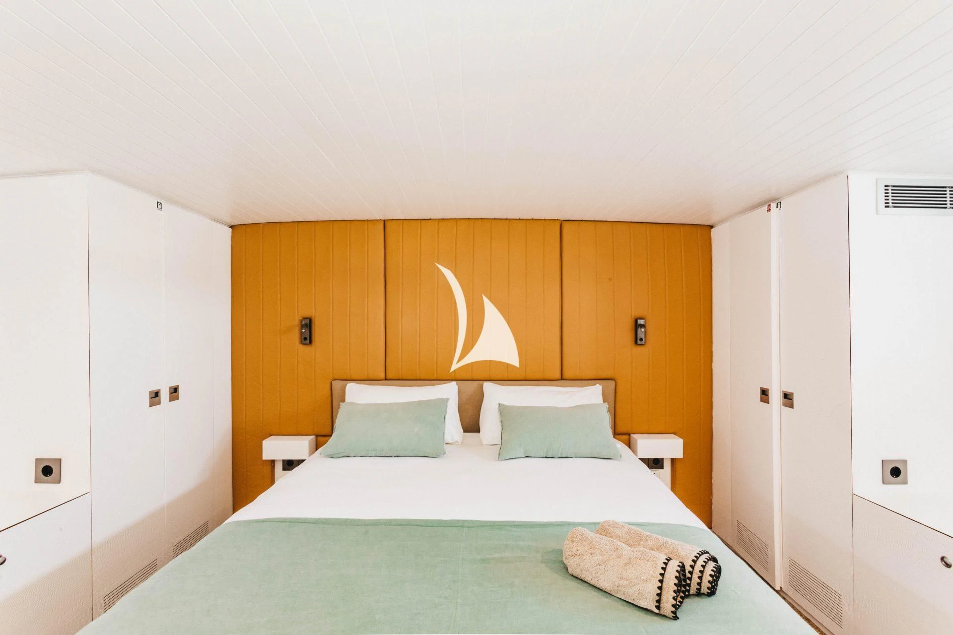 a bed with white sheets aboard CIUTADELLA Yacht for Sale