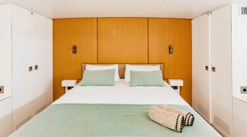 a bed with white sheets aboard CIUTADELLA Yacht for Sale