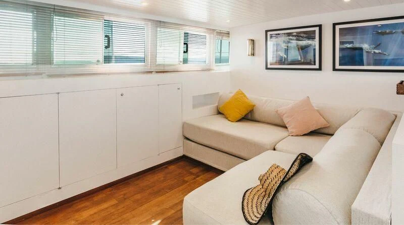 a white couch in a room aboard CIUTADELLA Yacht for Sale