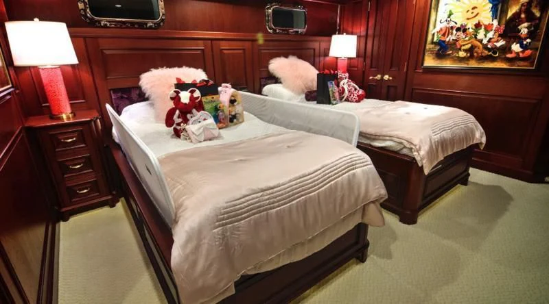 a bedroom with a bed and stuffed animals aboard SCORPIO Yacht for Sale